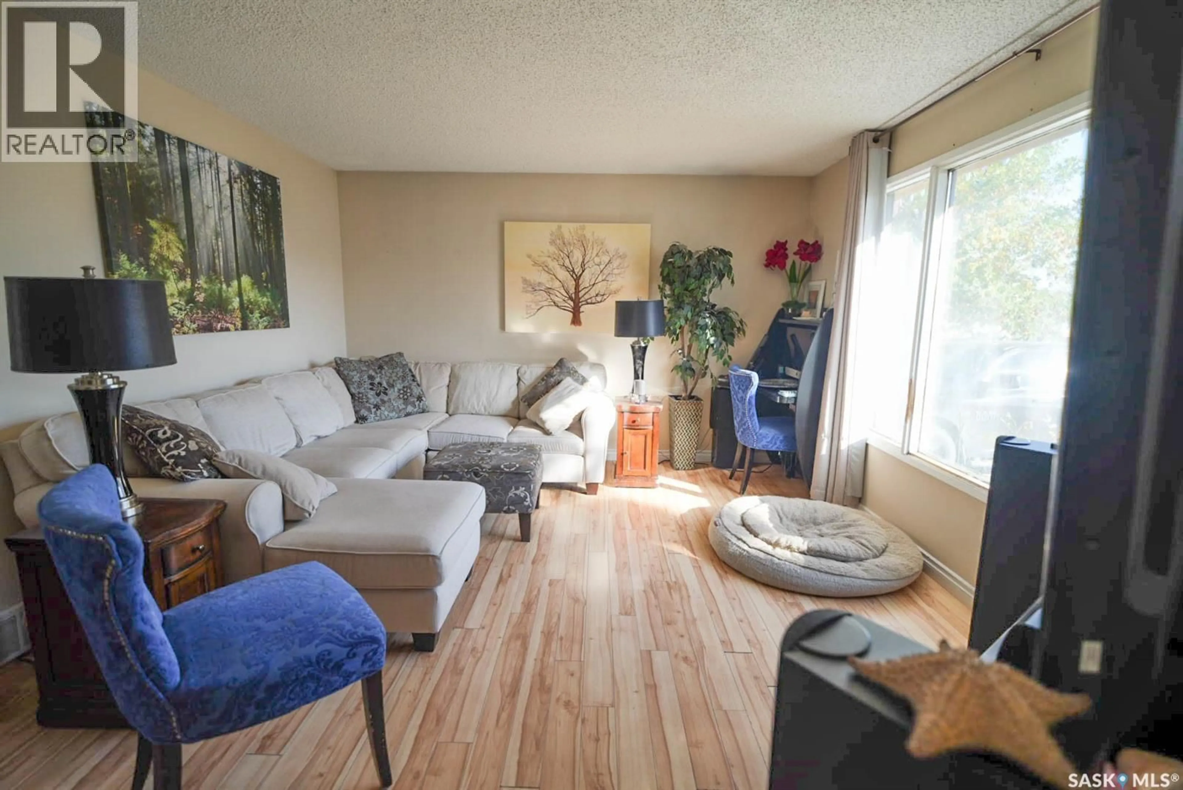 Living room with furniture, wood/laminate floor for 106 CLANCY DRIVE, Saskatoon Saskatchewan S7M4L2