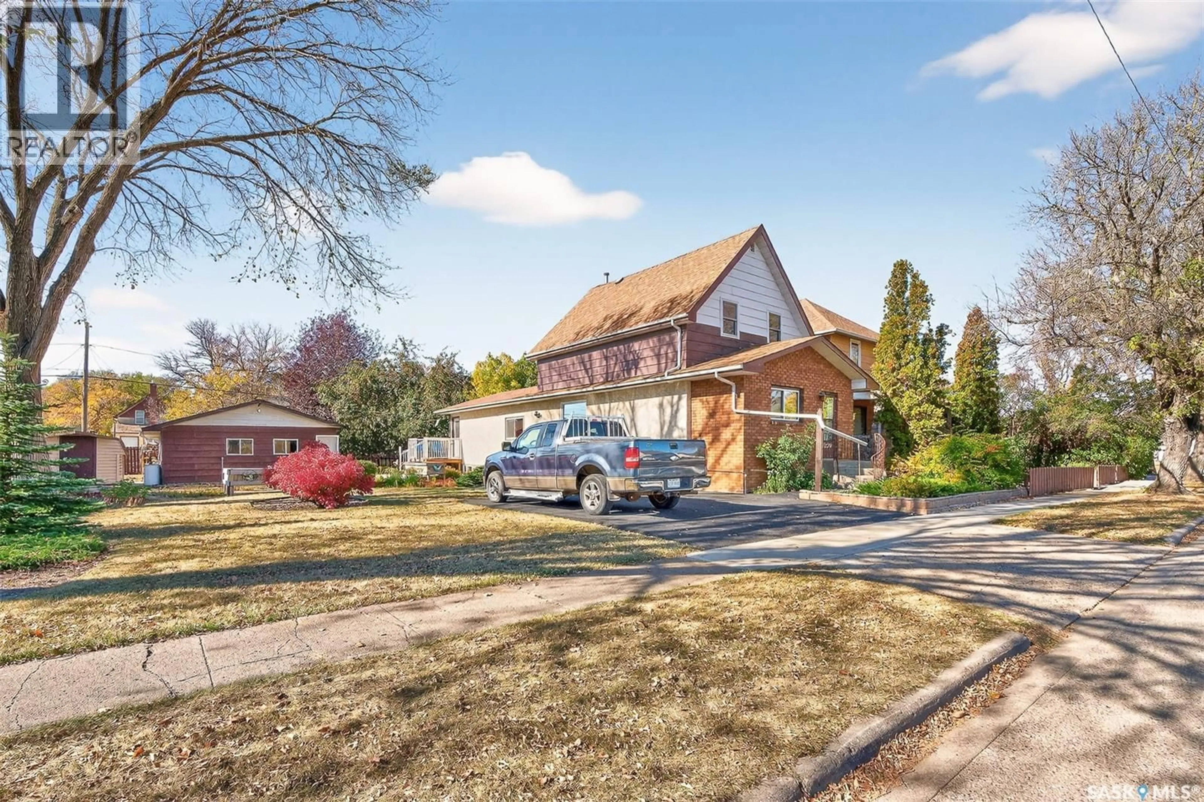 Home with brick exterior material, street for 1220 WILLOW AVENUE, Moose Jaw Saskatchewan S6H1H2