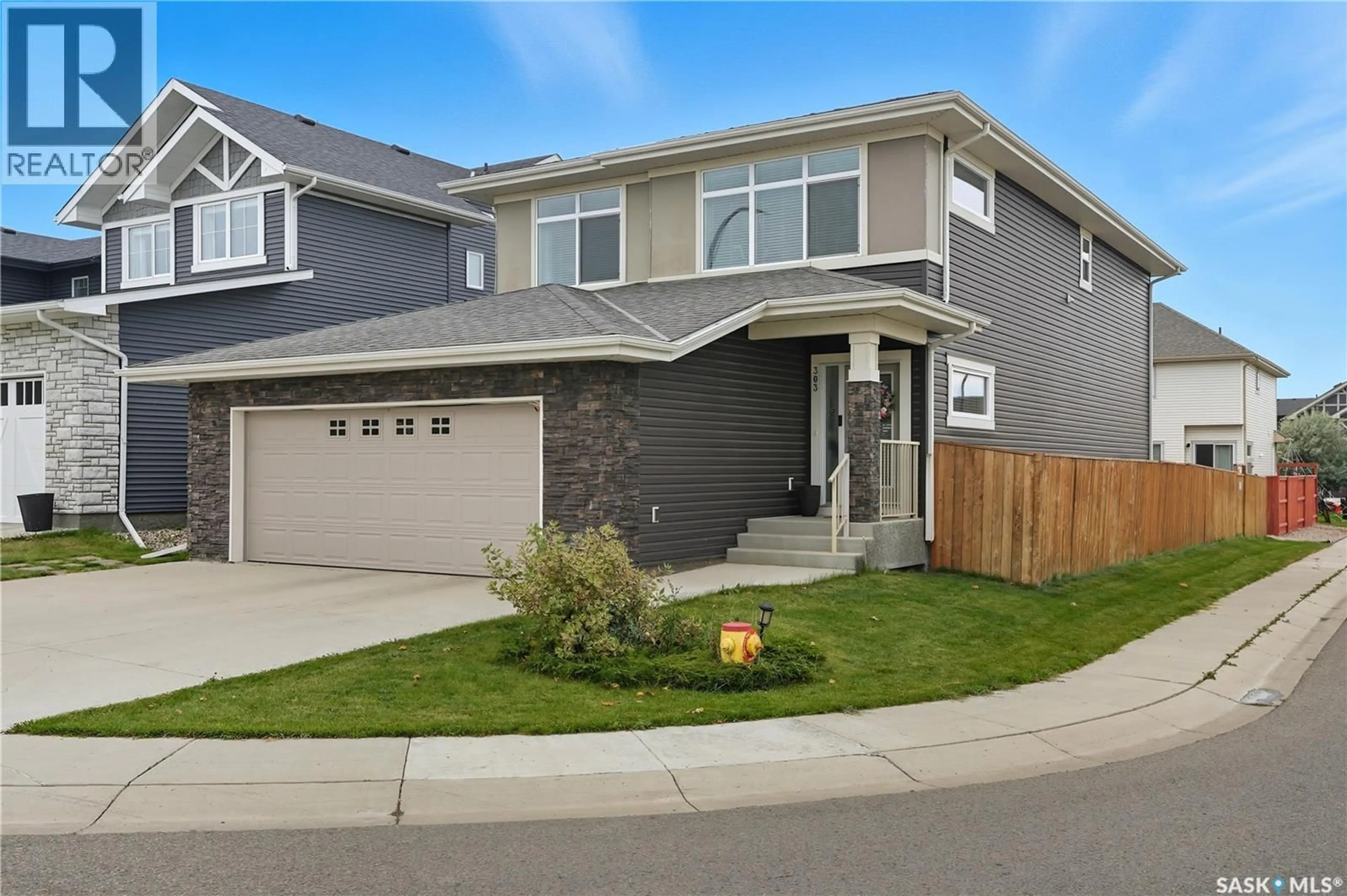 Home with vinyl exterior material, street for 303 DAGNONE CRESCENT, Saskatoon Saskatchewan S7V0P7