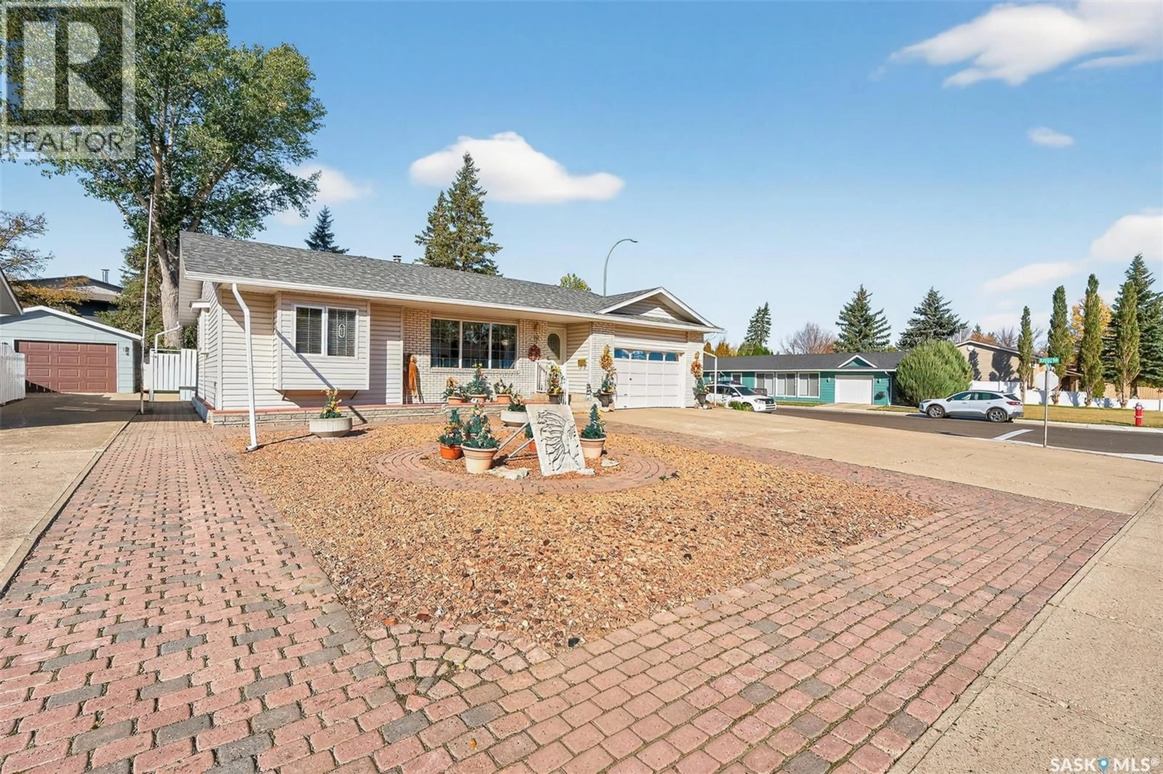 Home with vinyl exterior material, street for 18 BLUE SAGE DRIVE, Moose Jaw Saskatchewan S6J1C4