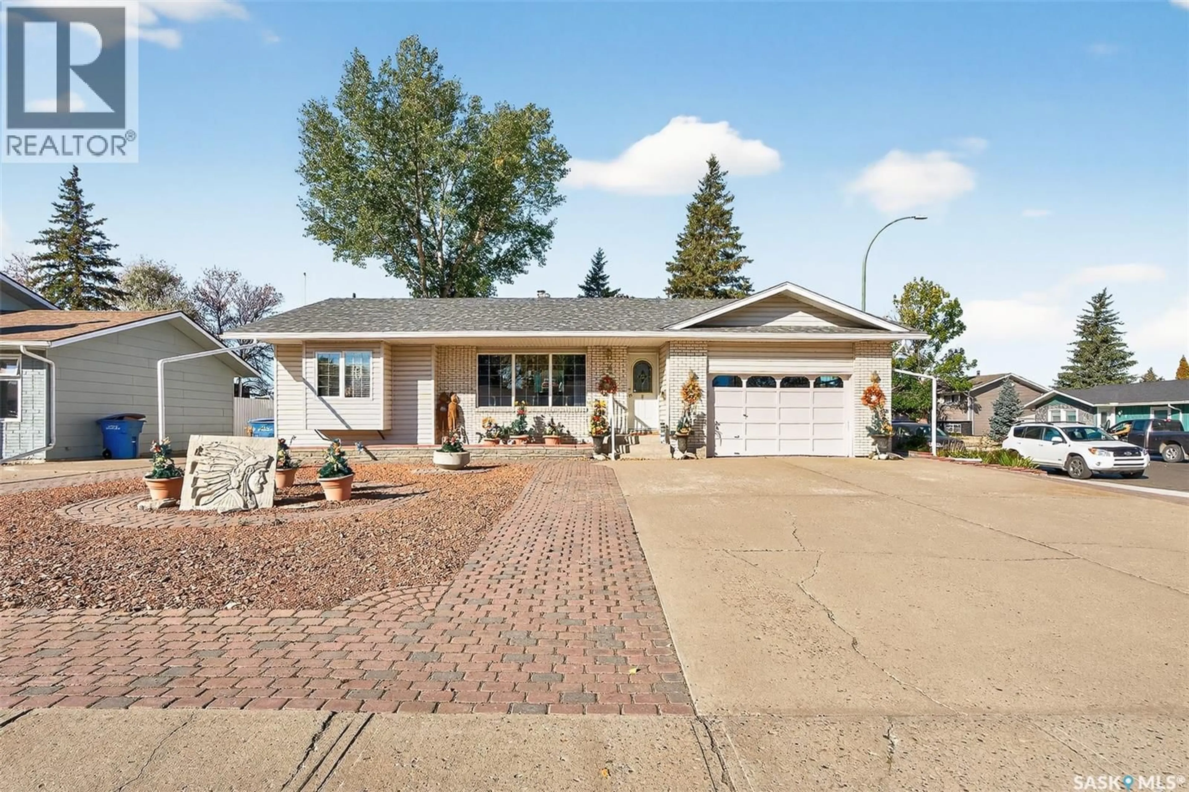 Home with vinyl exterior material, street for 18 BLUE SAGE DRIVE, Moose Jaw Saskatchewan S6J1C4