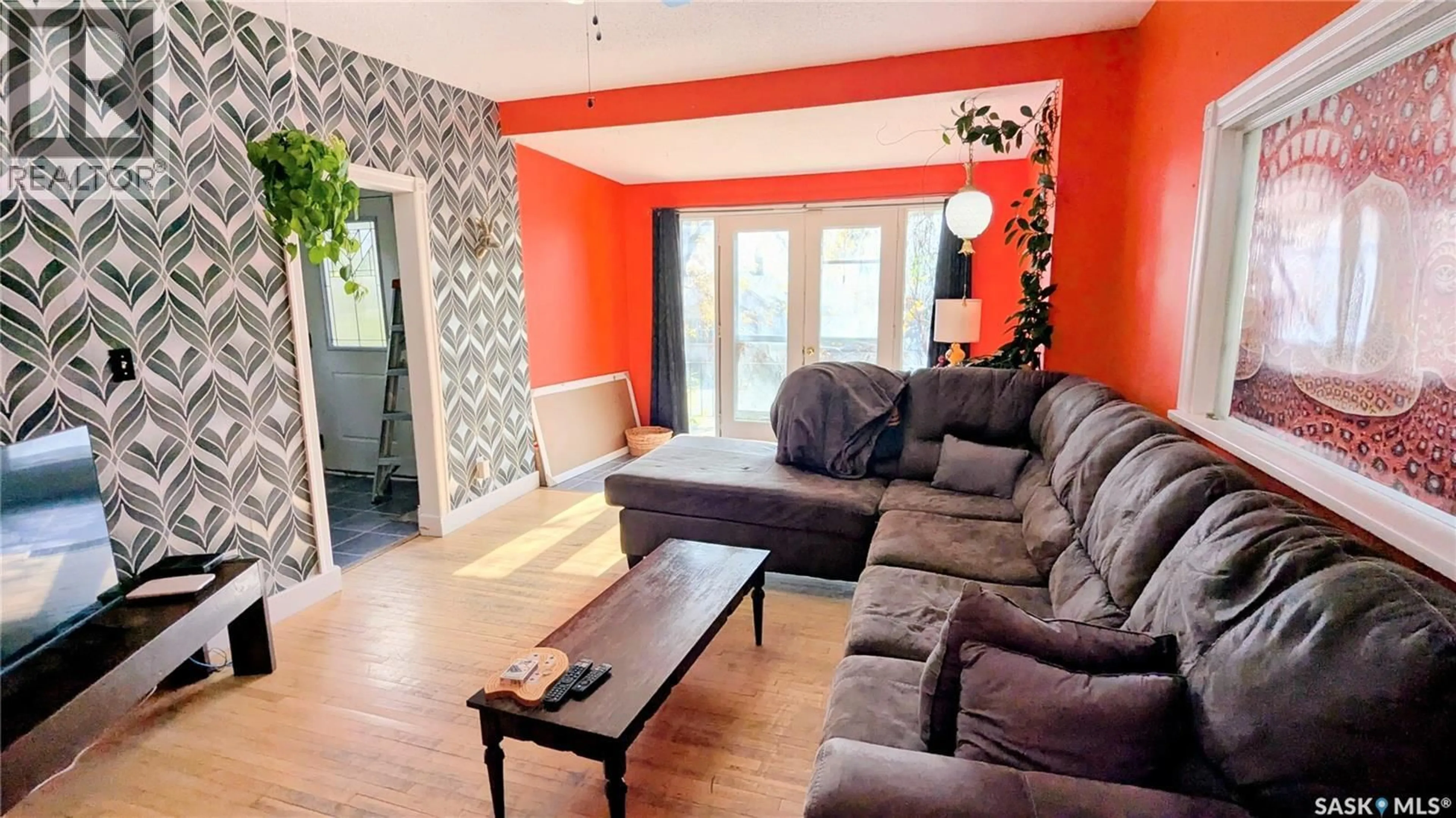 Living room with furniture, wood/laminate floor for 404 25TH STREET, Saskatoon Saskatchewan S7L0C8