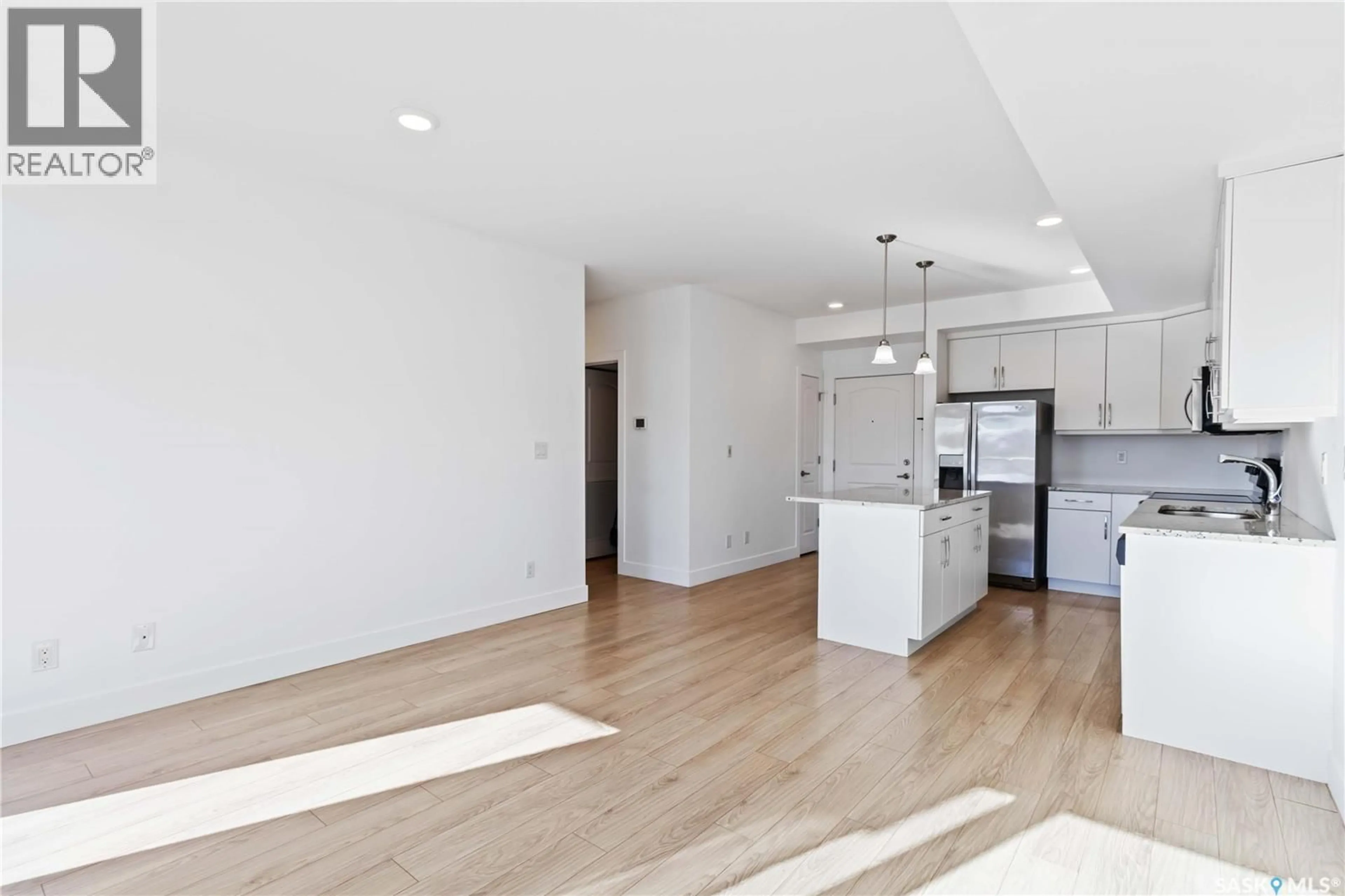 Open concept kitchen, wood/laminate floor for 111 770 CHILDERS CRESCENT, Saskatoon Saskatchewan S7L6W1