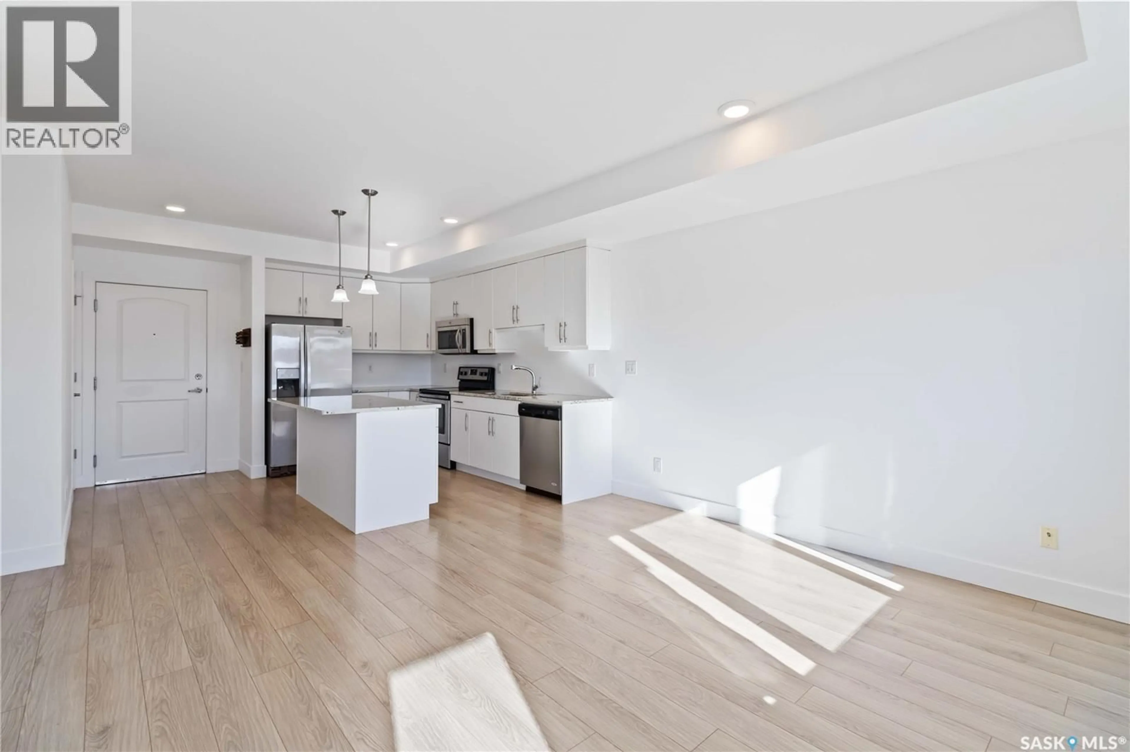 Open concept kitchen, wood/laminate floor for 111 770 CHILDERS CRESCENT, Saskatoon Saskatchewan S7L6W1