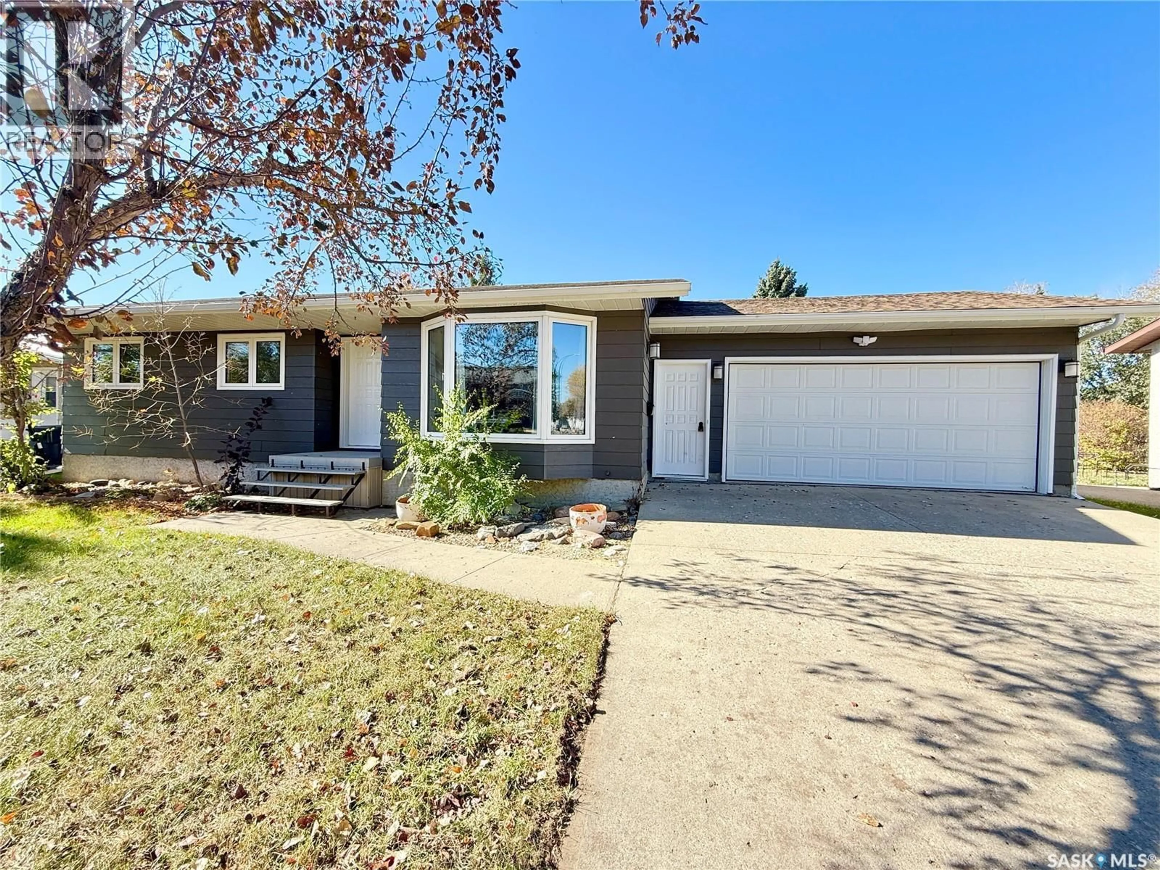 Home with vinyl exterior material, street for 225 18TH STREET, Weyburn Saskatchewan S4H3A8