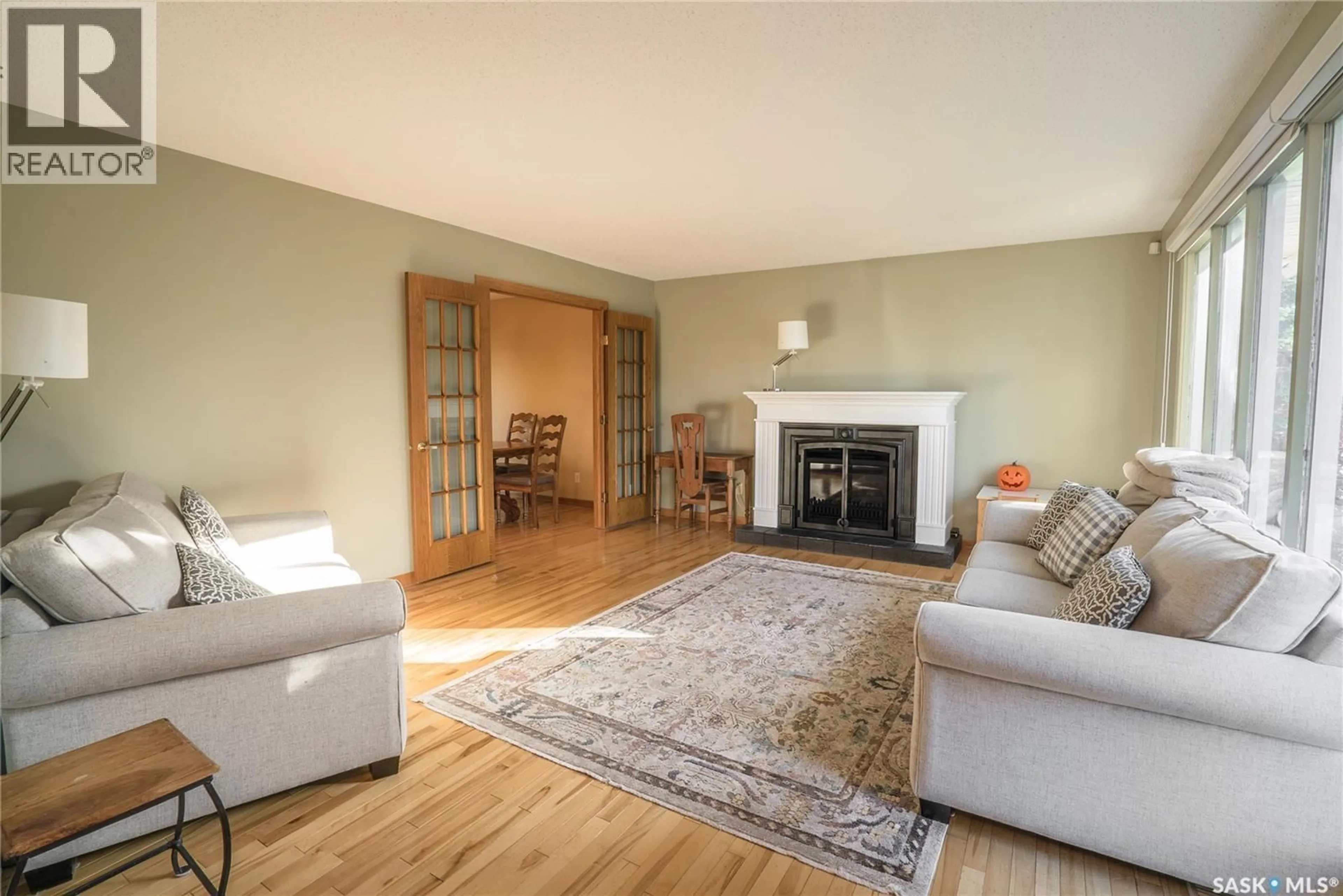Living room with furniture, wood/laminate floor for 78 CHAMPLIN CRESCENT, Saskatoon Saskatchewan S7H3R3