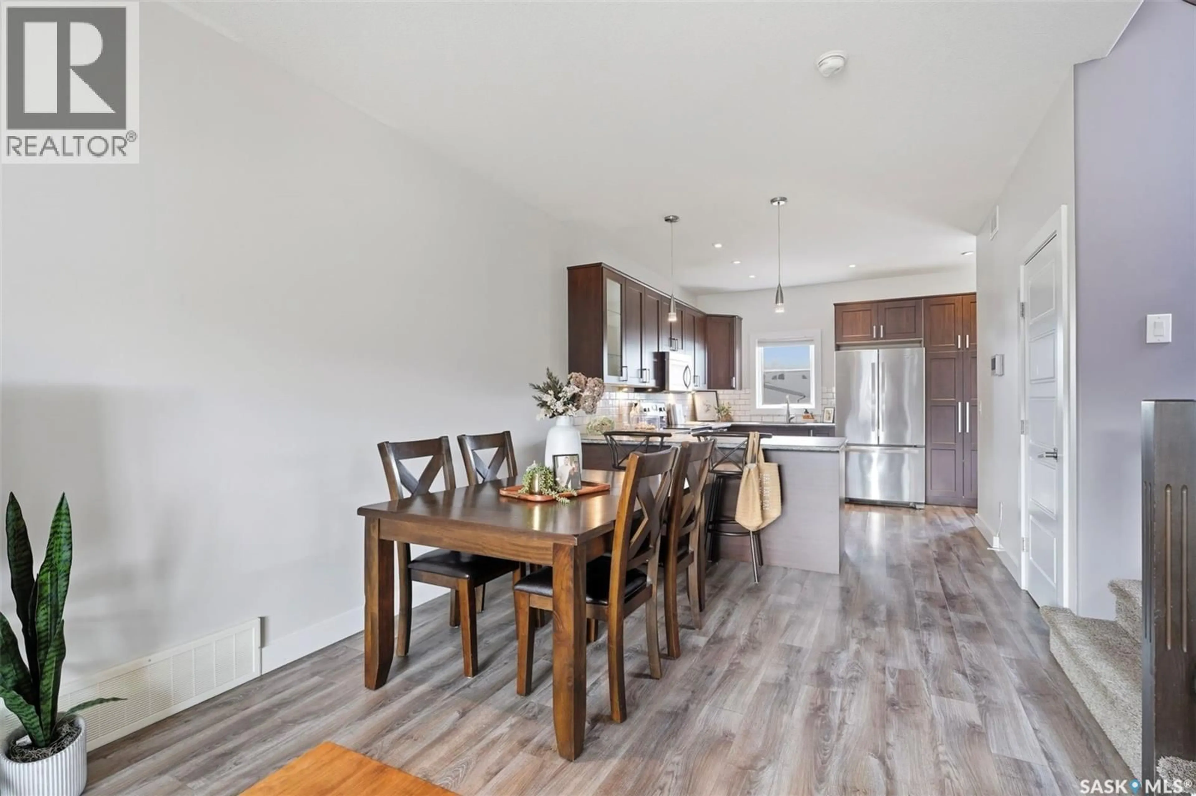 Open concept kitchen, wood/laminate floor for 218 KLOPPENBURG WAY, Saskatoon Saskatchewan S7W0N6