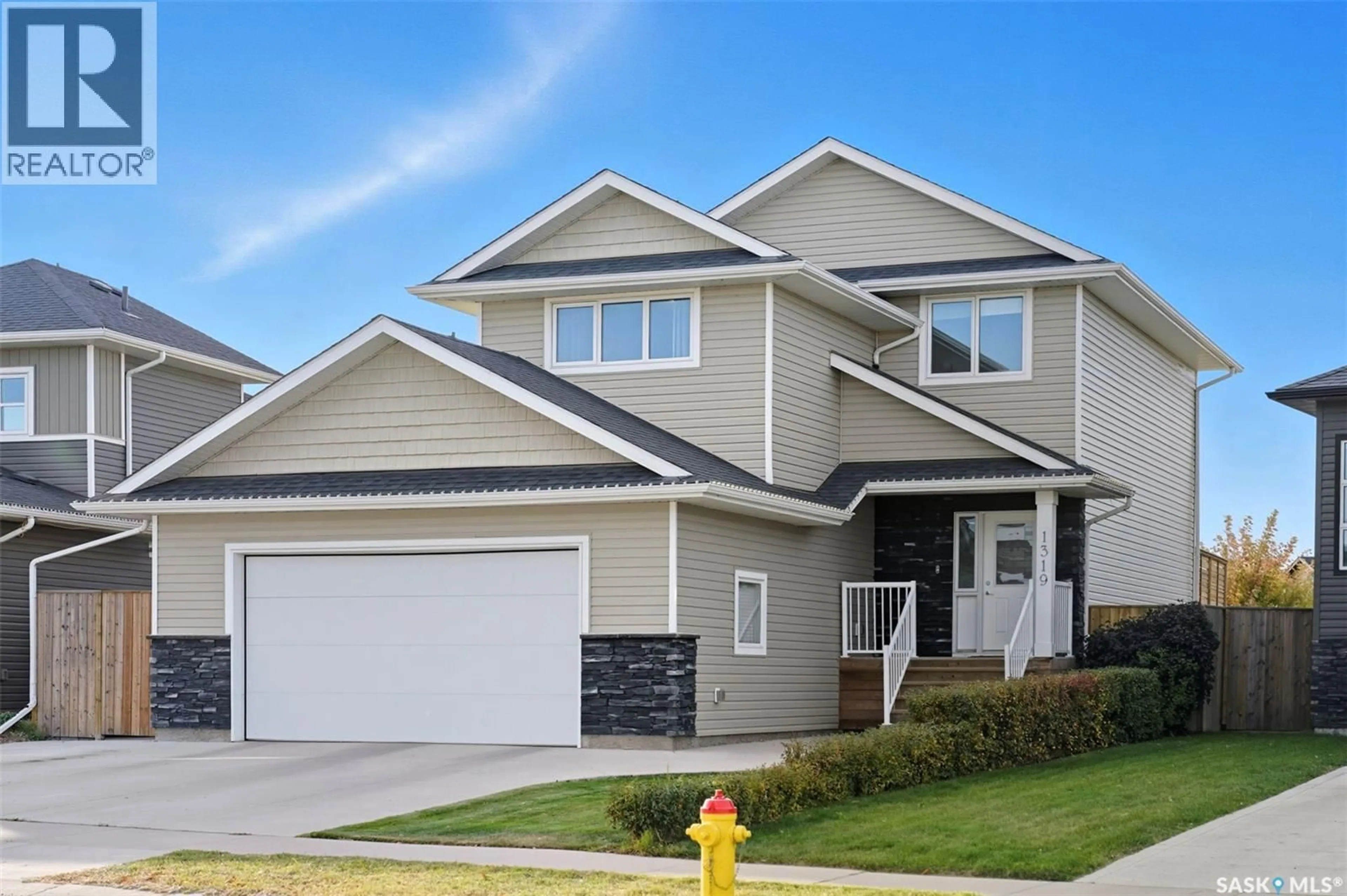Home with vinyl exterior material, street for 1319 STEEVES AVENUE, Saskatoon Saskatchewan S7R0M4
