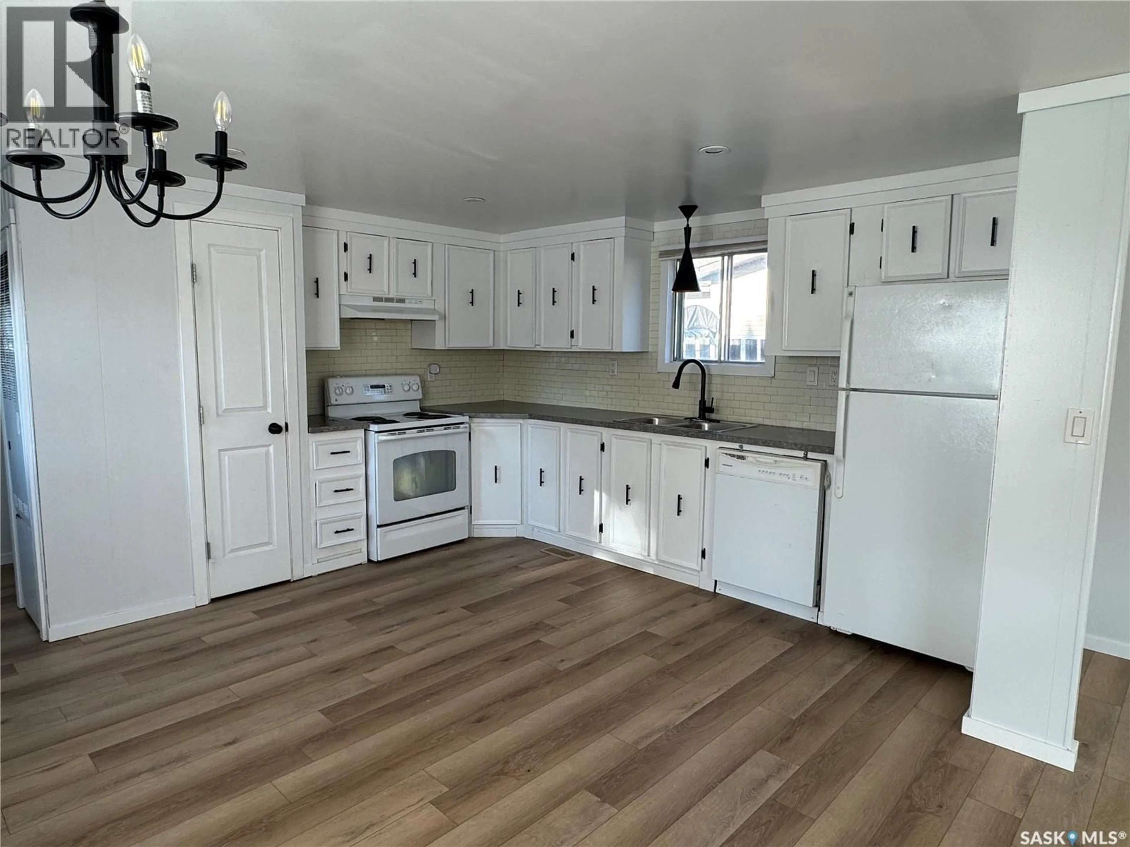 Open concept kitchen, wood/laminate floor for 1119 DALBY CRESCENT, La Ronge Saskatchewan S0J1L0