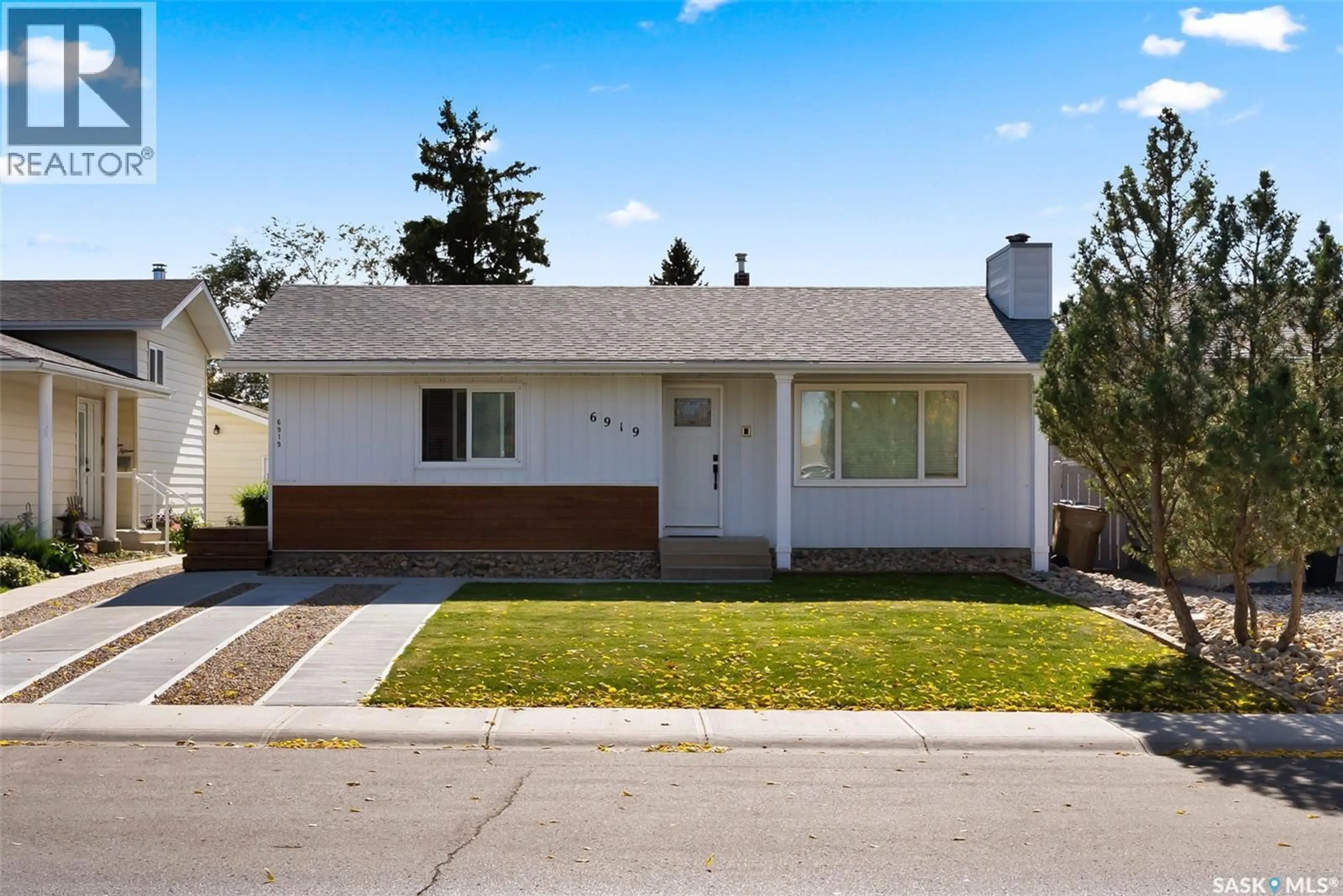 Home with vinyl exterior material, street for 6919 1ST AVENUE, Regina Saskatchewan S4X1C8