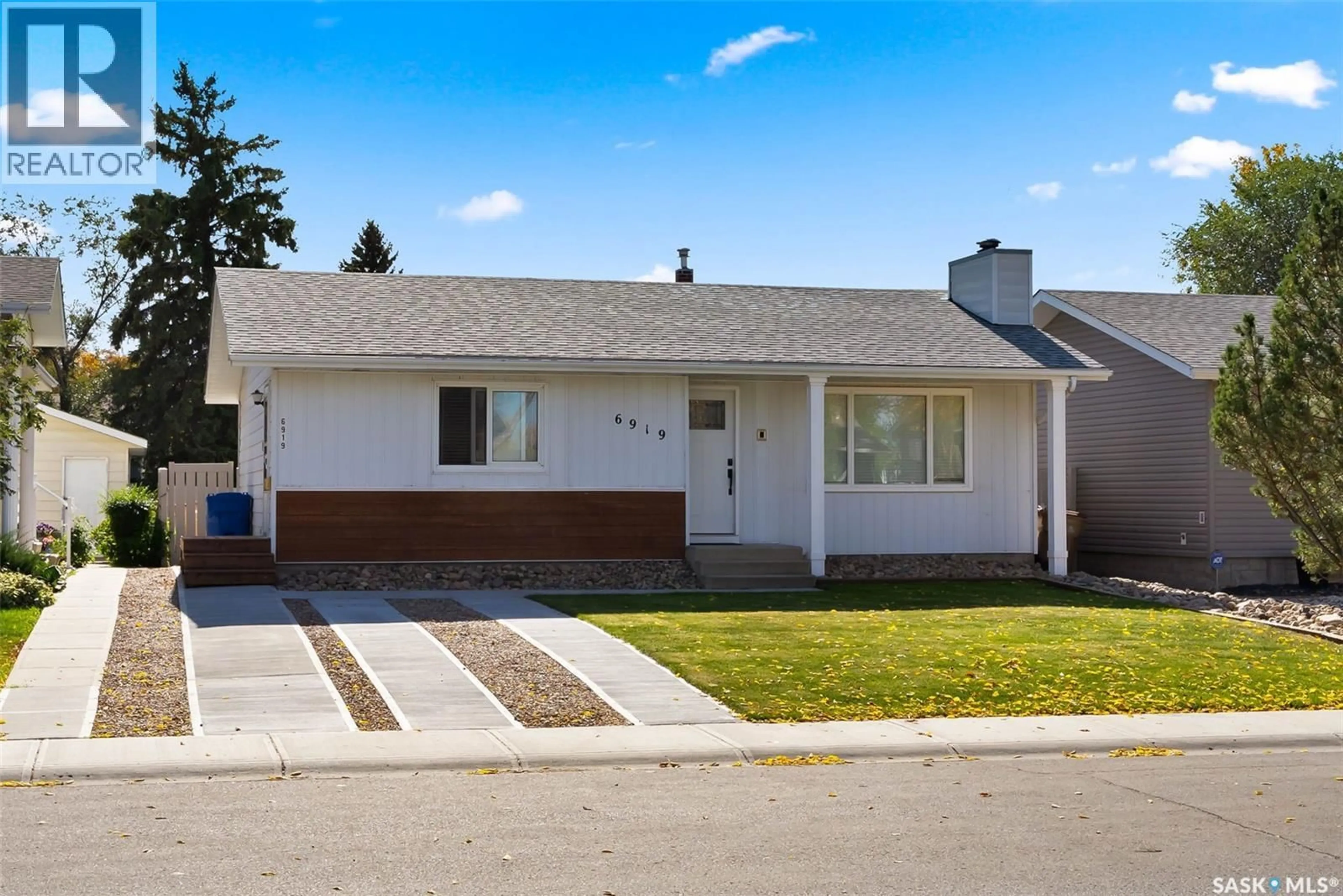 Home with vinyl exterior material, street for 6919 1ST AVENUE, Regina Saskatchewan S4X1C8