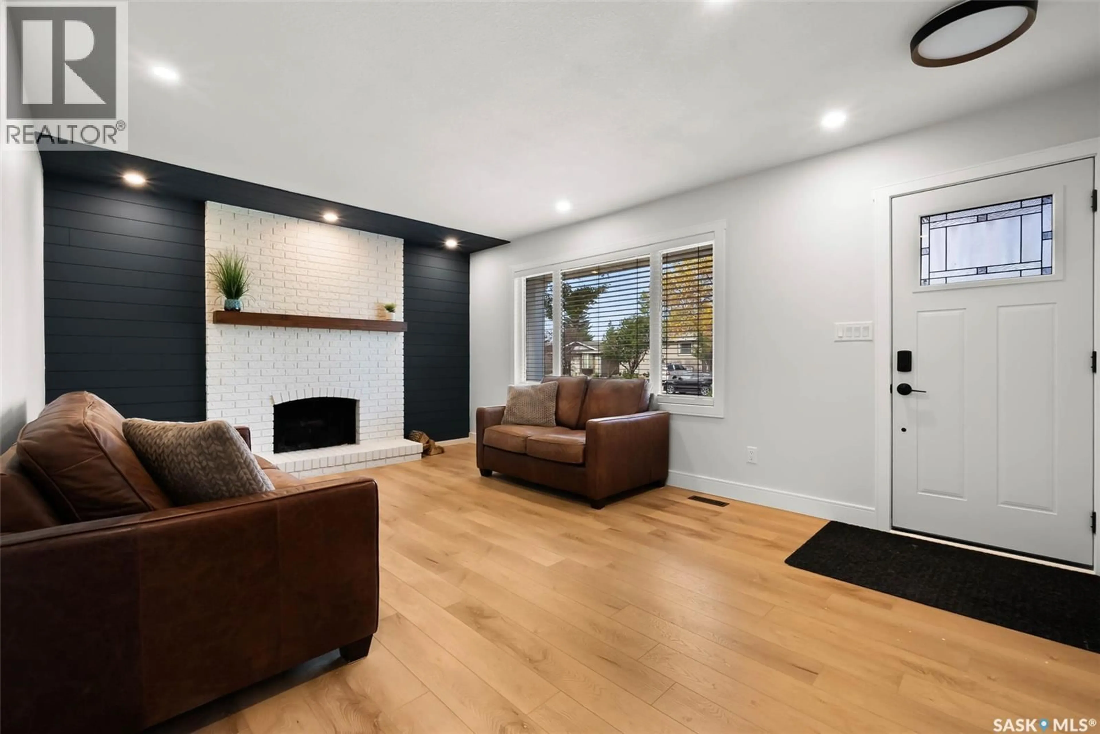 Living room with furniture, wood/laminate floor for 6919 1ST AVENUE, Regina Saskatchewan S4X1C8