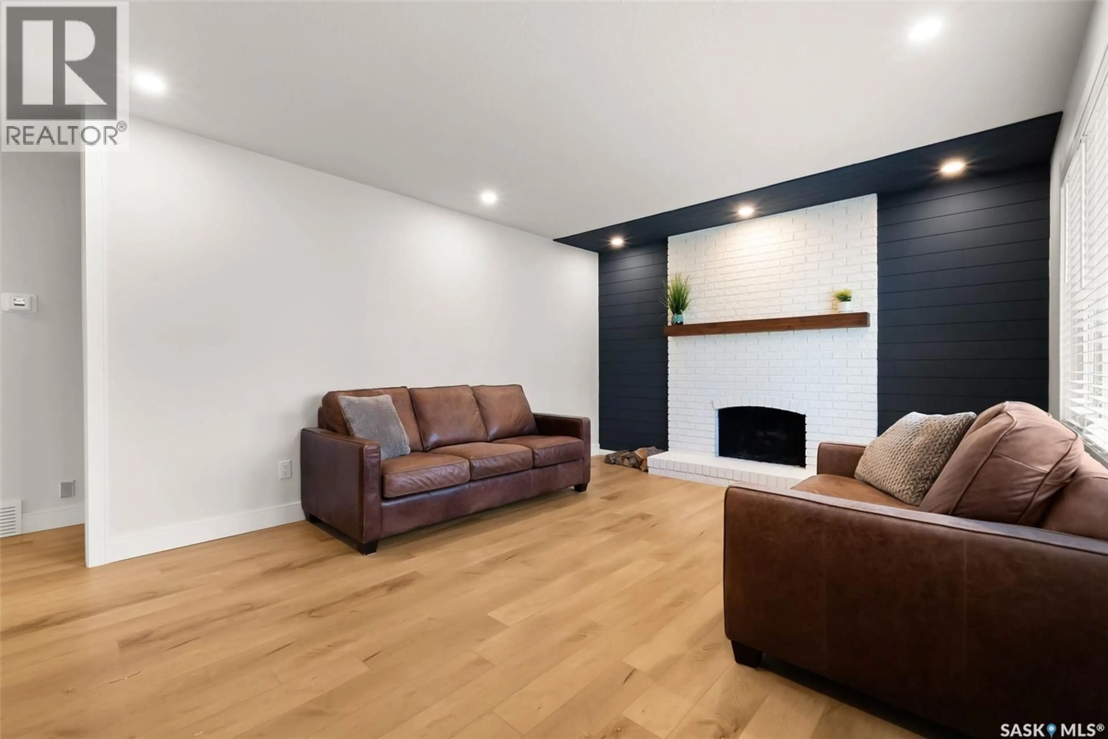 Living room with furniture, wood/laminate floor for 6919 1ST AVENUE, Regina Saskatchewan S4X1C8