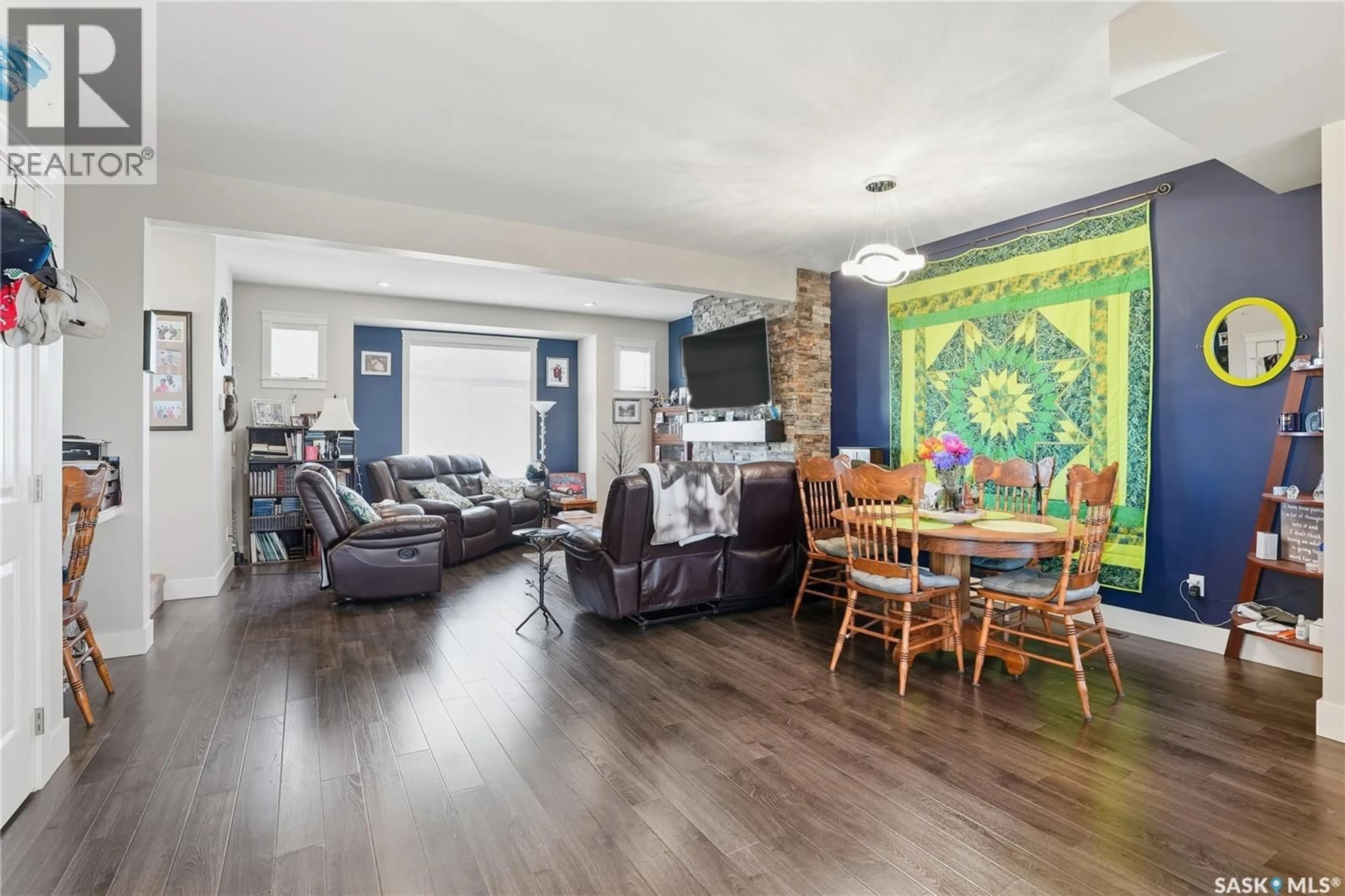 Living room with furniture, wood/laminate floor for 12 425 LANGER PLACE, Warman Saskatchewan S0K4S1