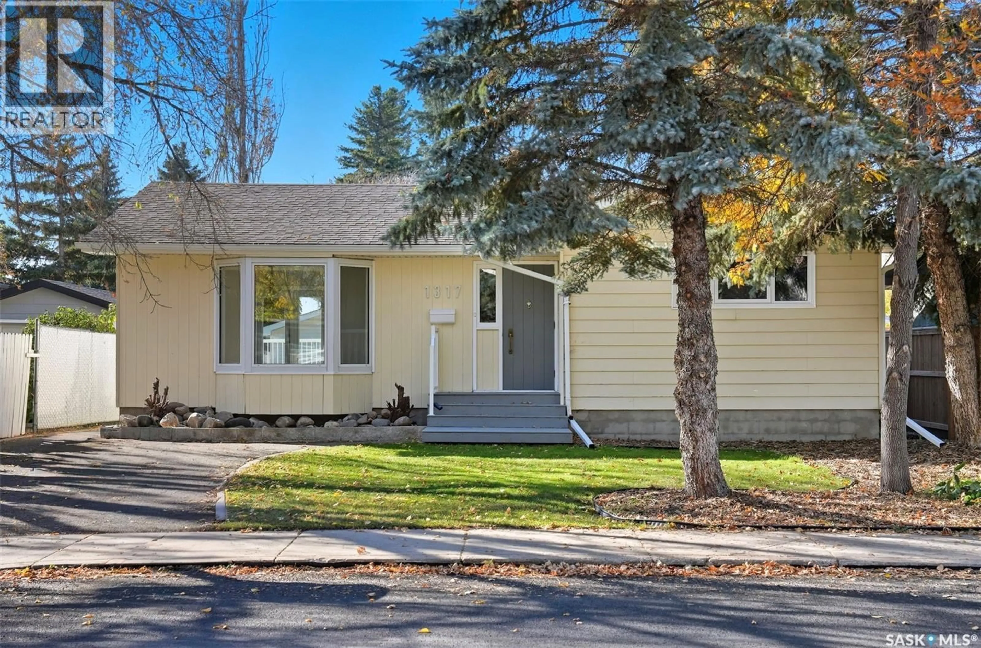 Home with vinyl exterior material, street for 1317 ELEVATOR ROAD, Saskatoon Saskatchewan S7M3X3