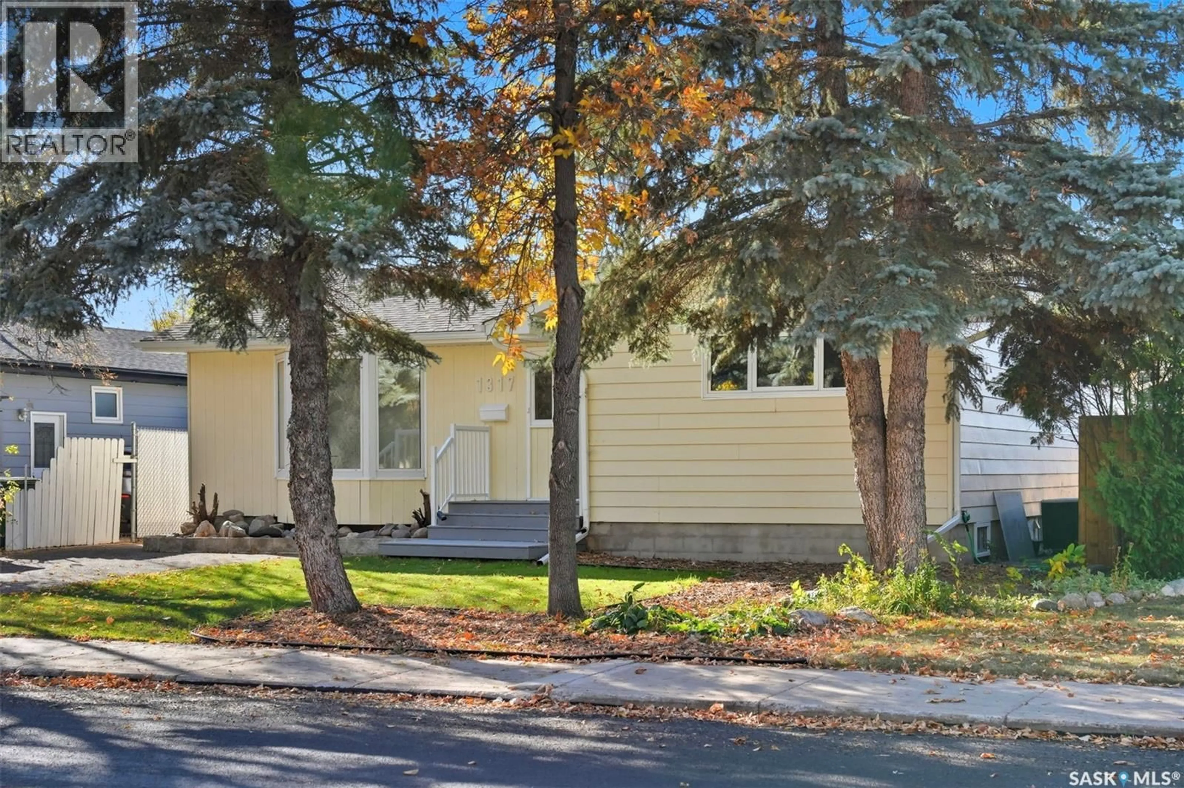 Home with vinyl exterior material, street for 1317 ELEVATOR ROAD, Saskatoon Saskatchewan S7M3X3