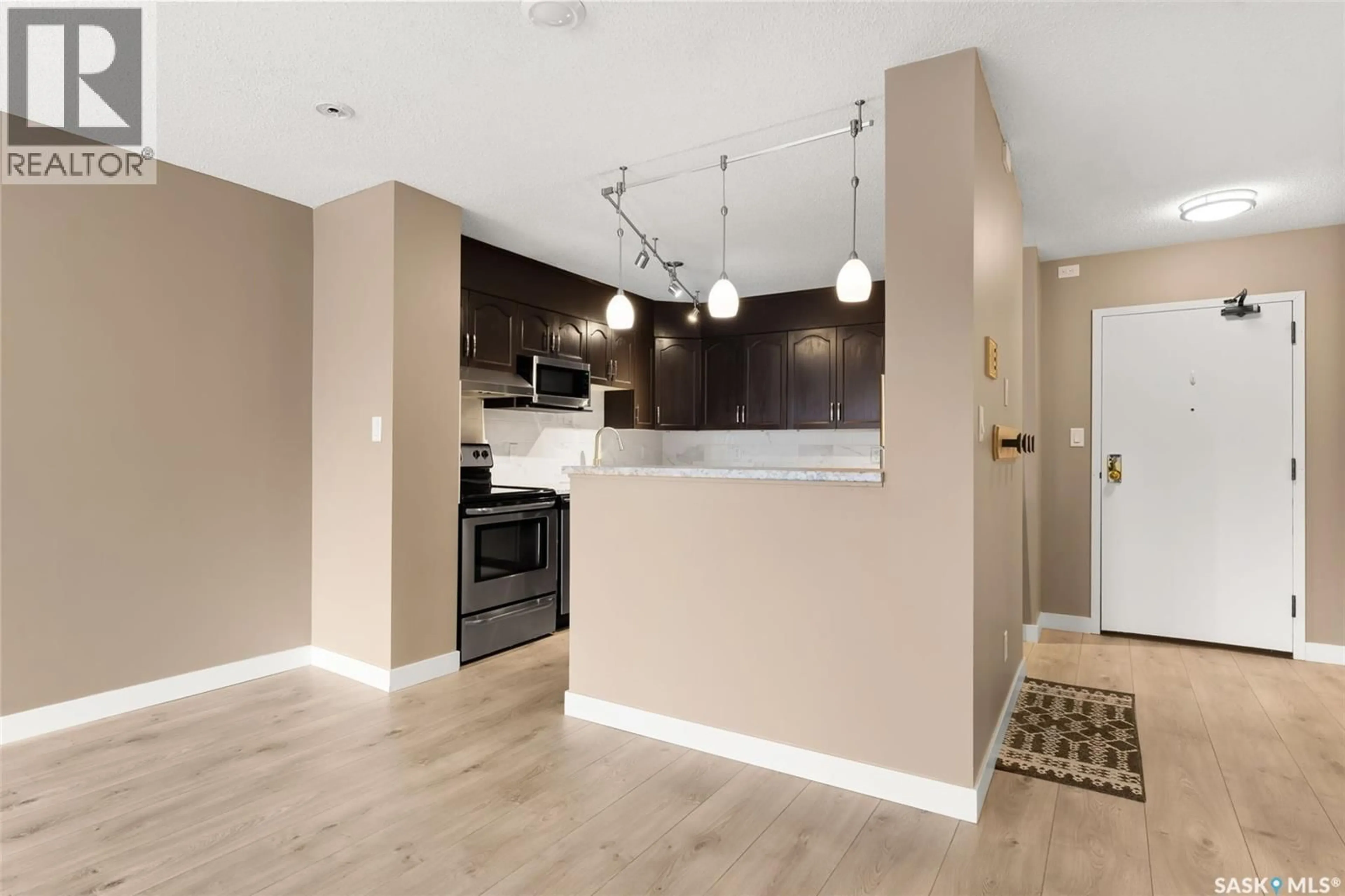 Open concept kitchen, wood/laminate floor for 307 - 2275 MCINTYRE STREET, Regina Saskatchewan S4P2S1