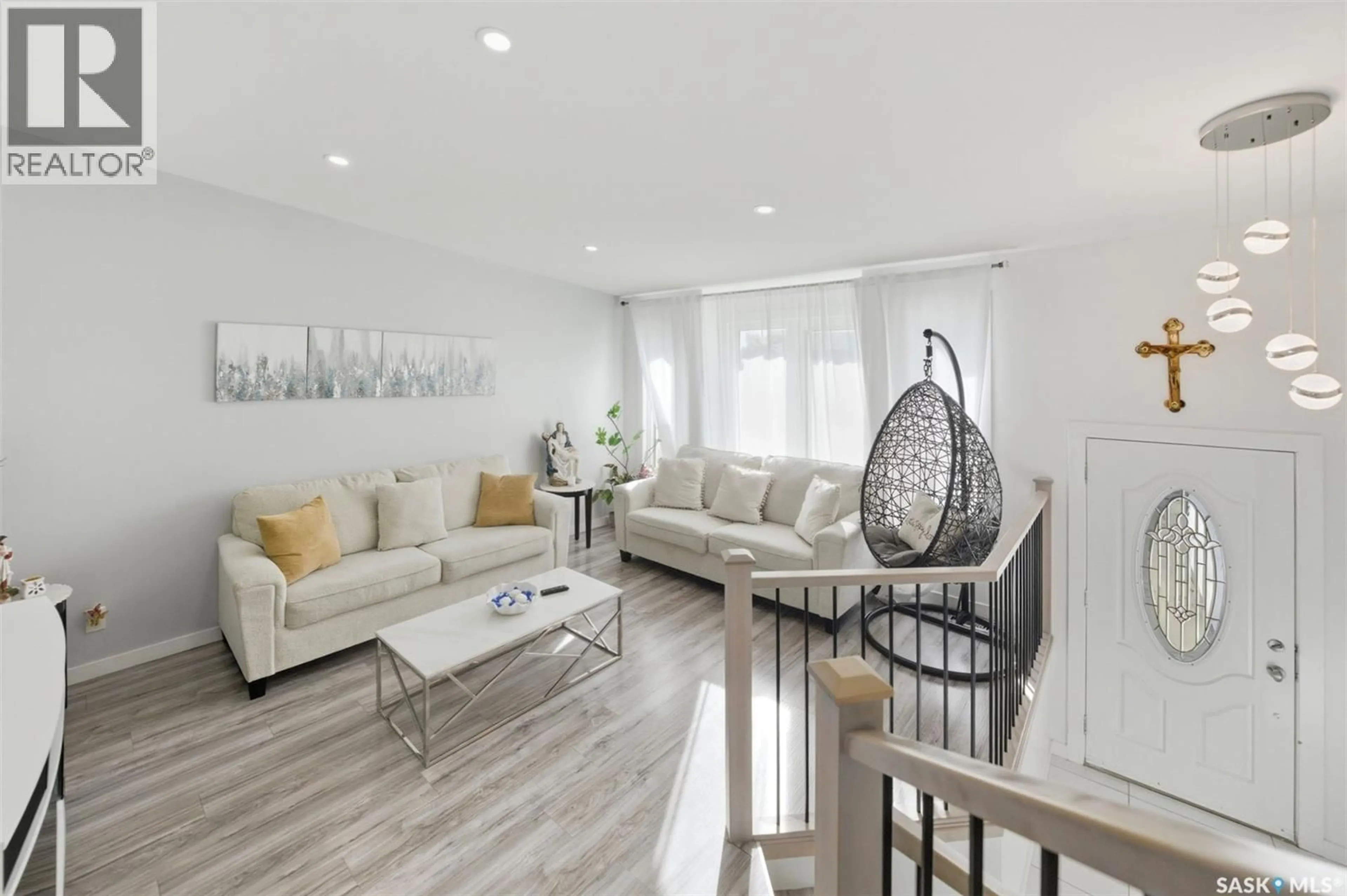 Living room with furniture, wood/laminate floor for 1010 HASLAM CRESCENT, Saskatoon Saskatchewan S7S1C8