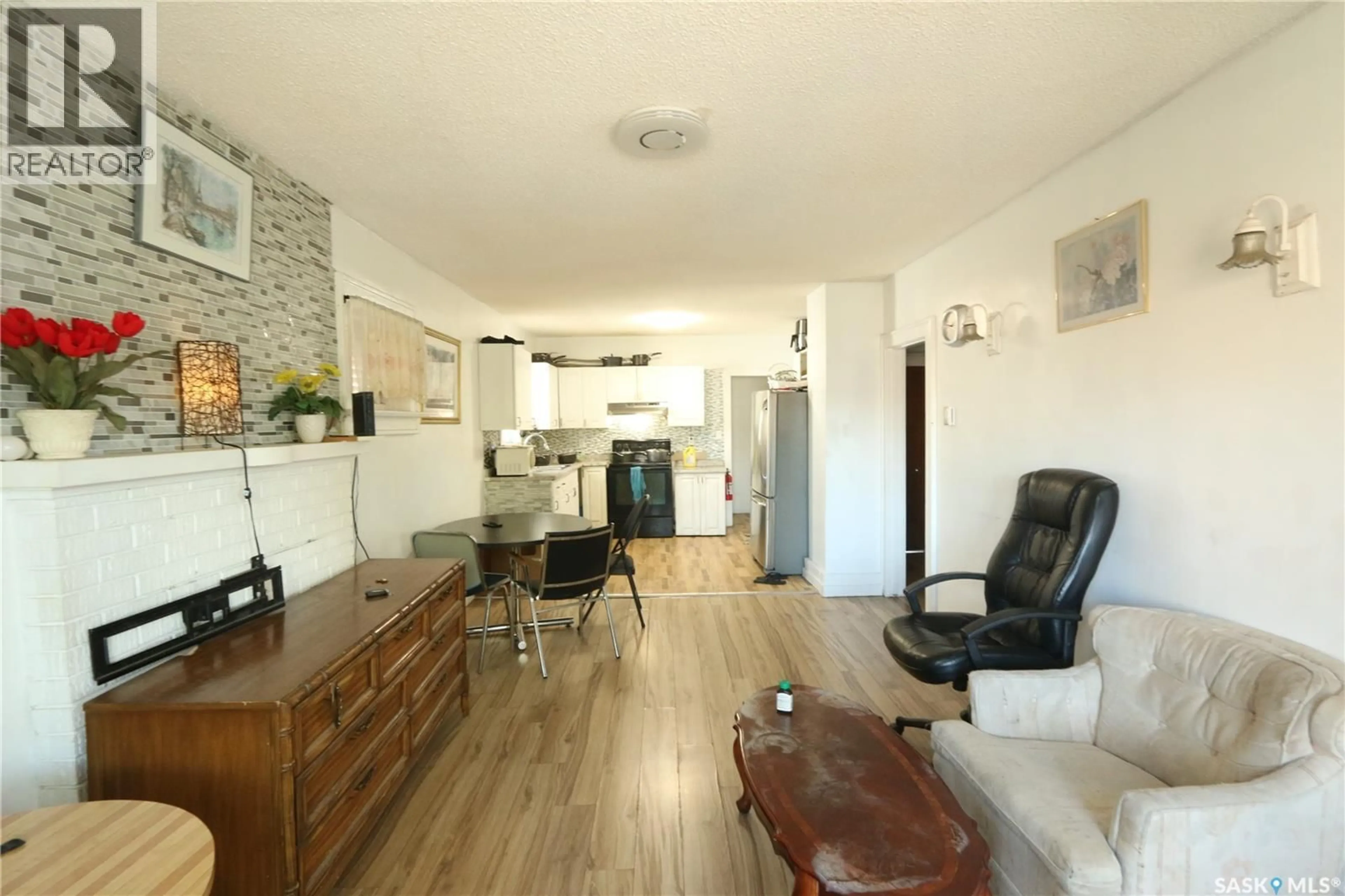 Living room with furniture, wood/laminate floor for 1115 ROBINSON STREET, Regina Saskatchewan S4T2N1