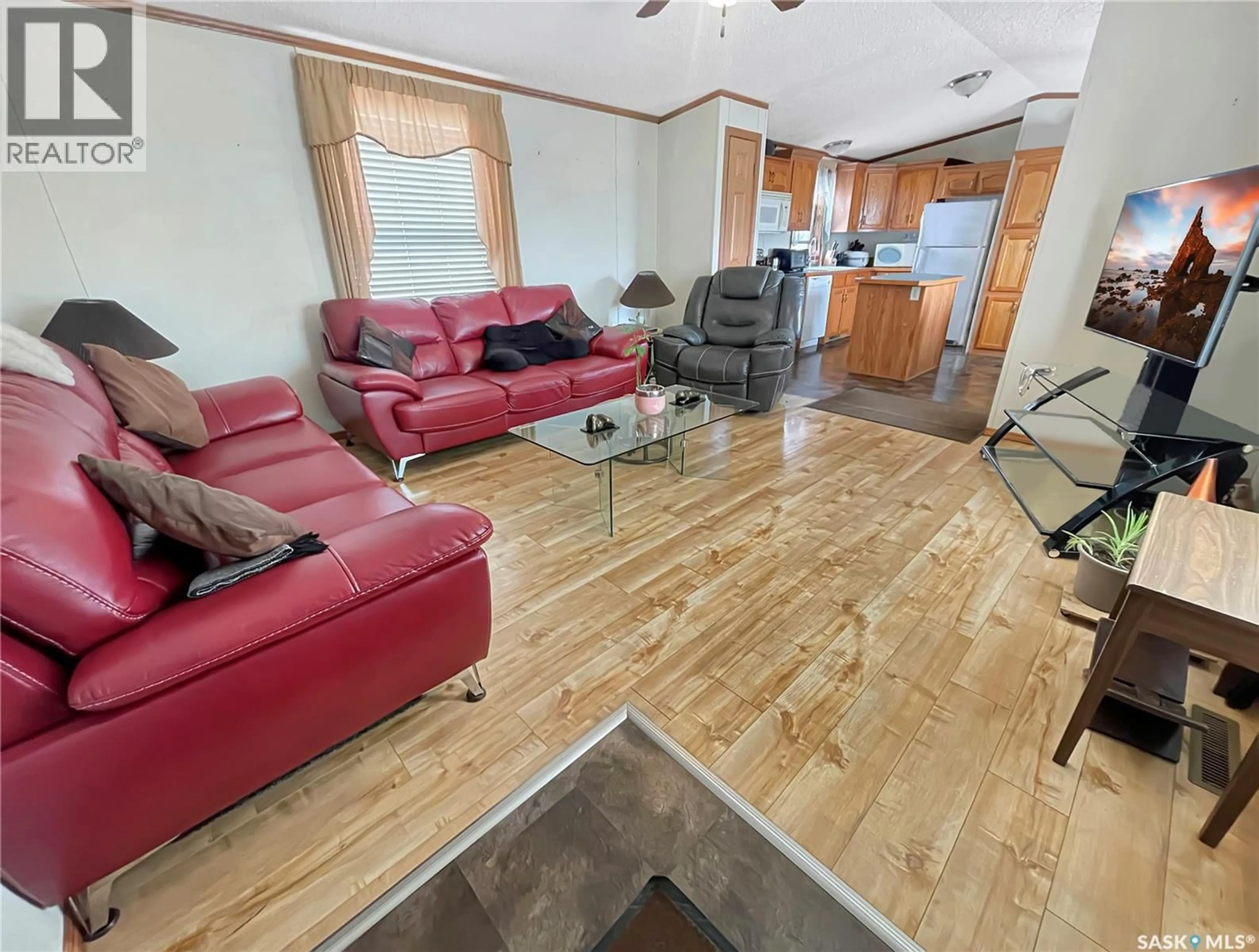Living room with furniture, wood/laminate floor for 128 PRAIRIE SUN COURT, Swift Current Saskatchewan S9H3X6