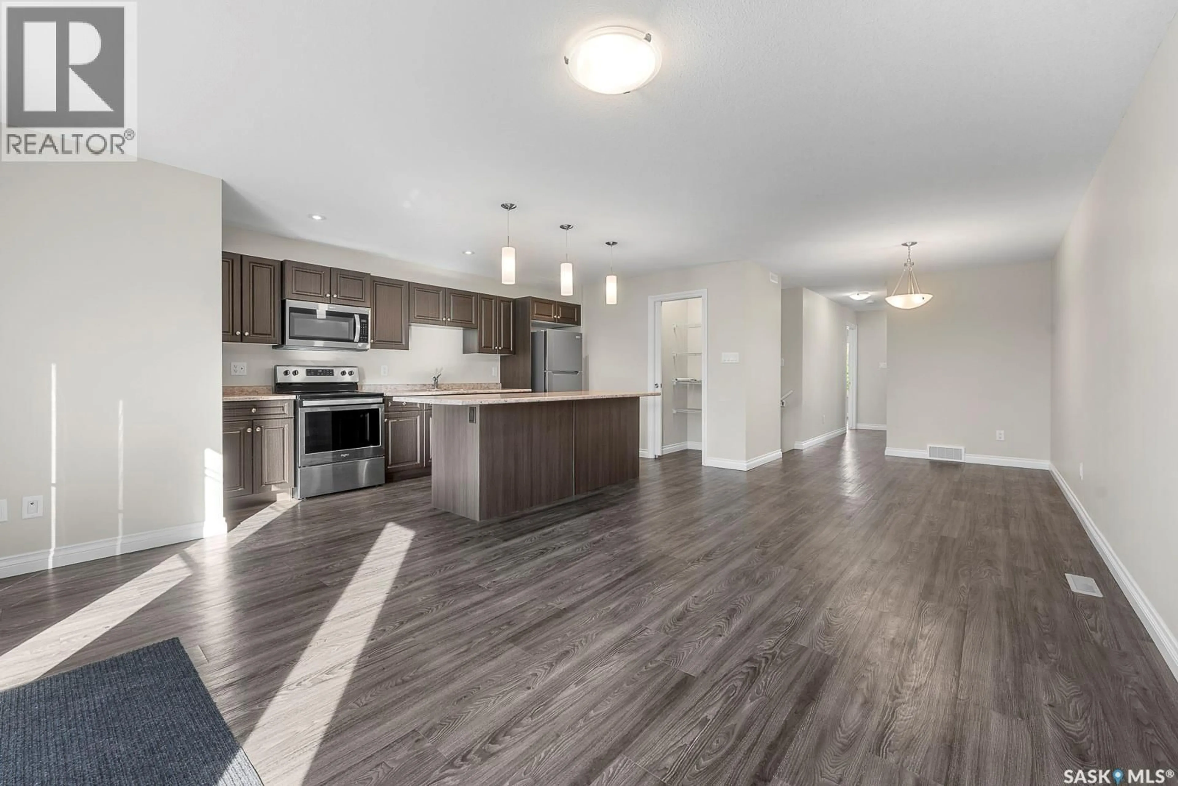 Open concept kitchen, wood/laminate floor for 2252 PASQUA STREET, Regina Saskatchewan S4T4M4