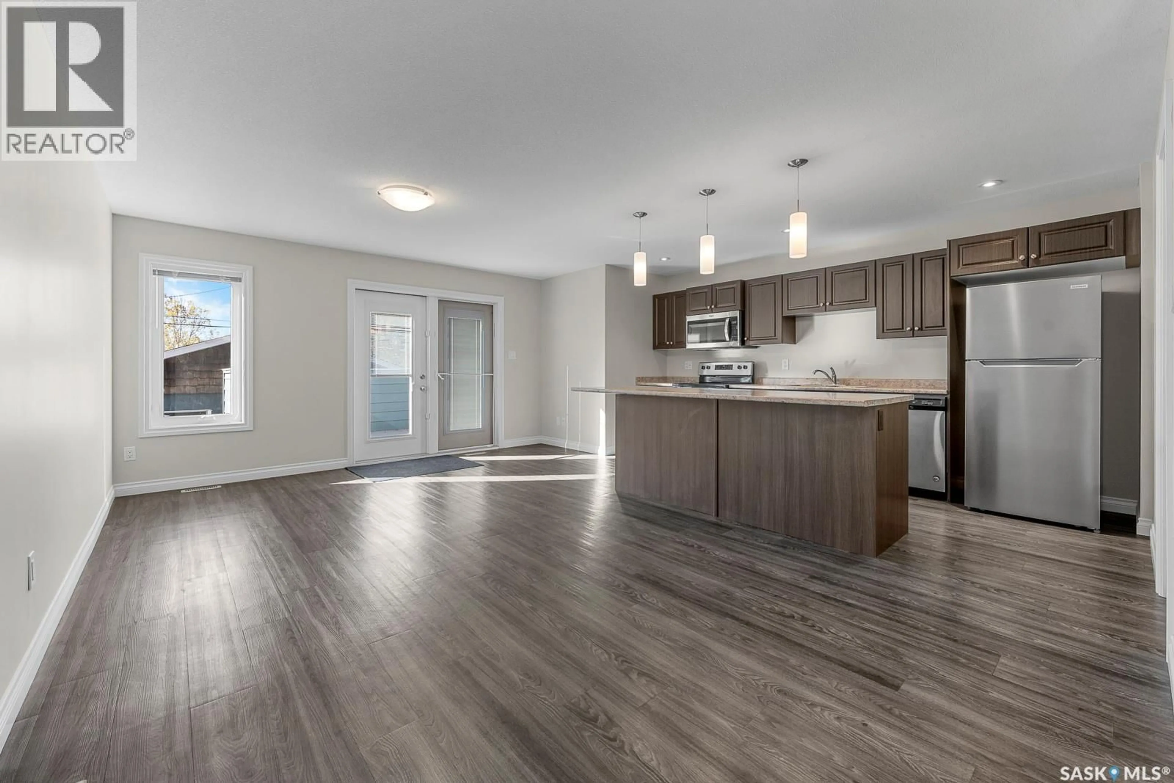 Open concept kitchen, wood/laminate floor for 2252 PASQUA STREET, Regina Saskatchewan S4T4M4