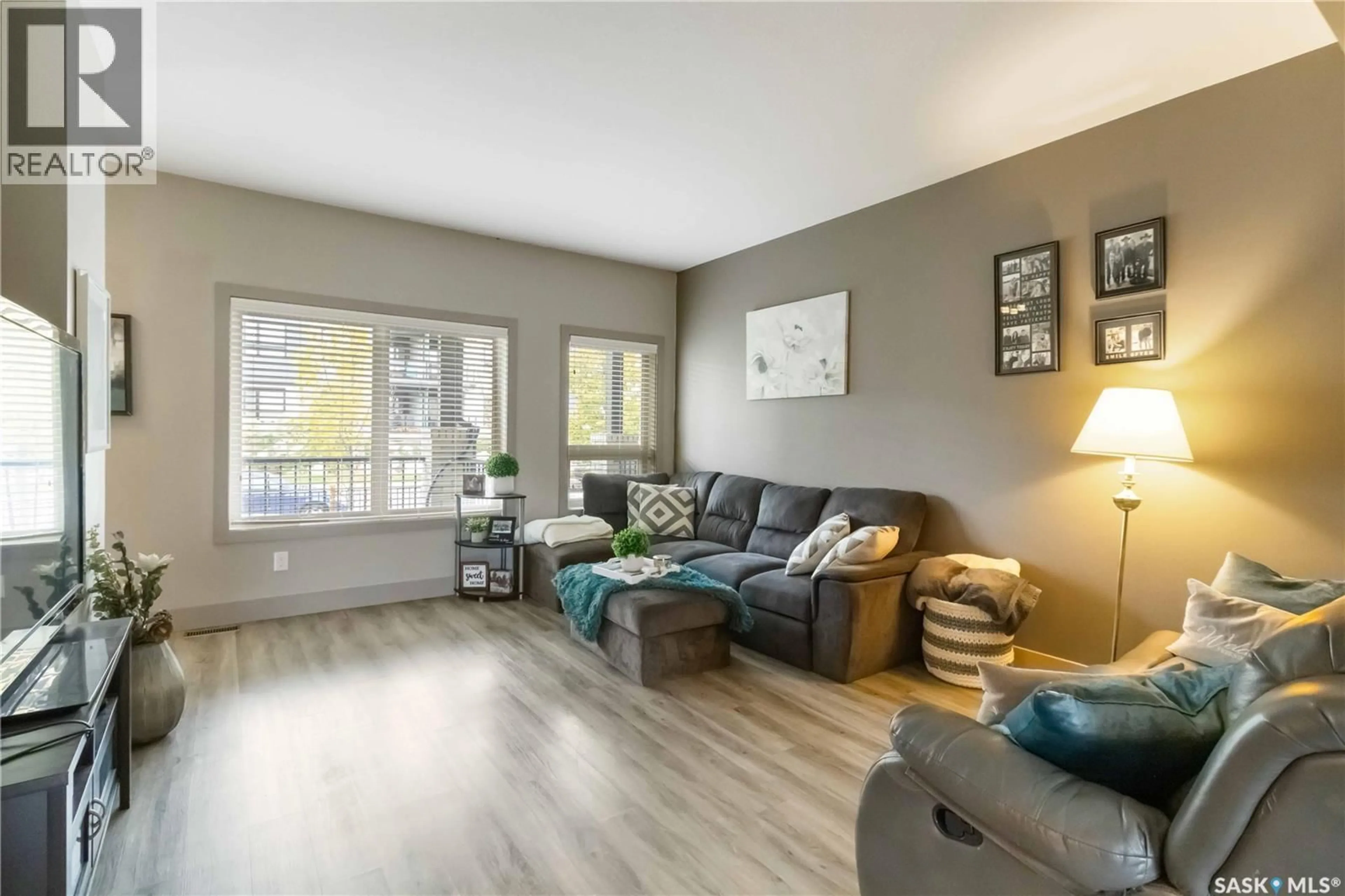 Living room with furniture, wood/laminate floor for 232 MANINGAS BEND, Saskatoon Saskatchewan S7W0P5