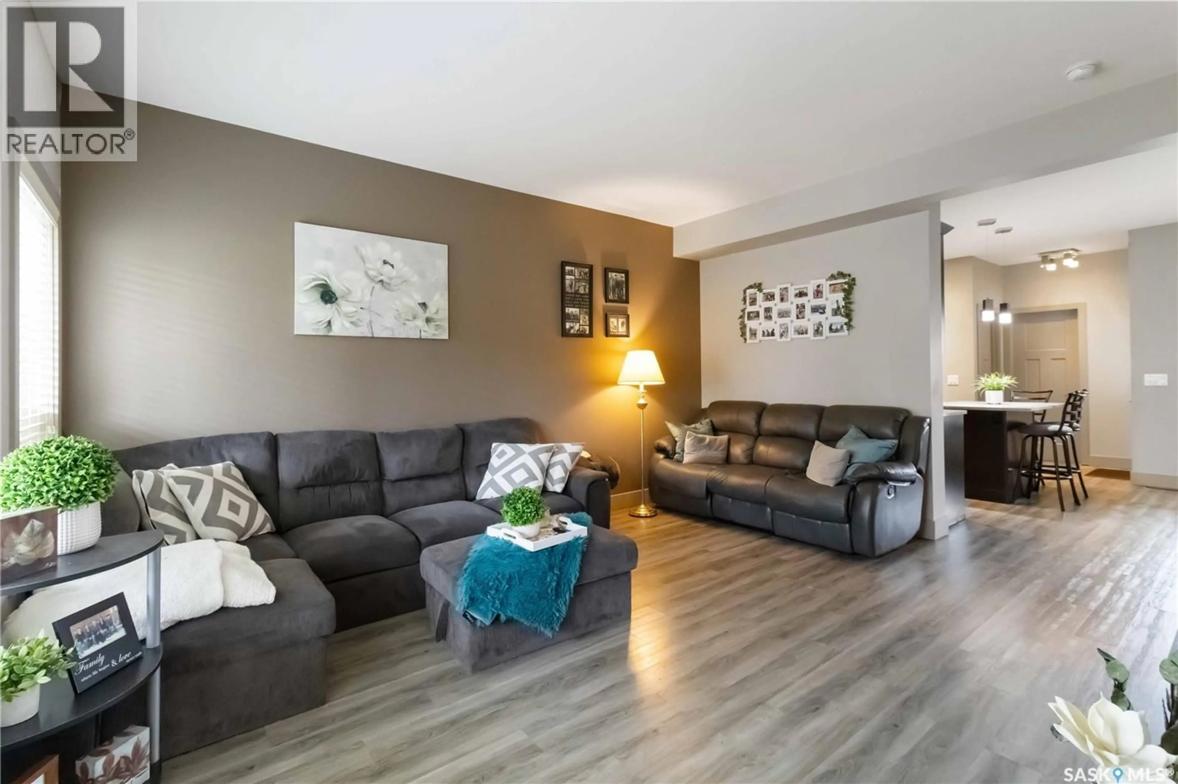 Living room with furniture, wood/laminate floor for 232 MANINGAS BEND, Saskatoon Saskatchewan S7W0P5