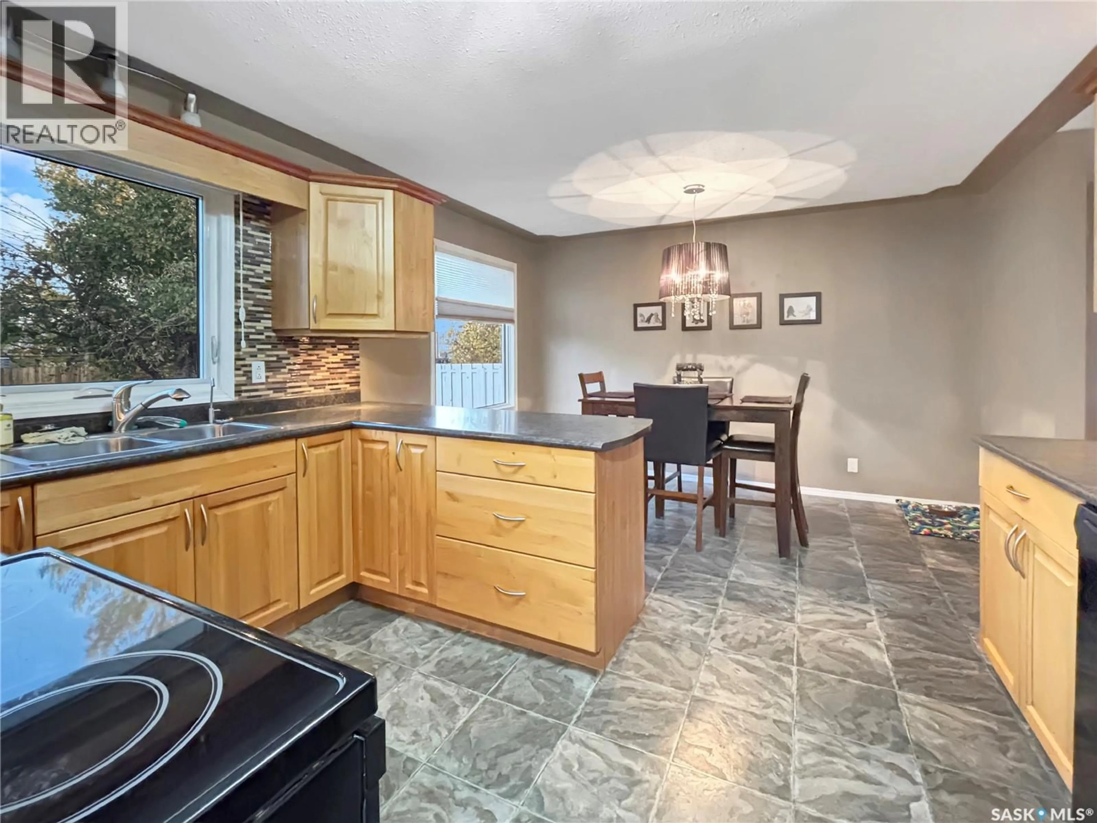 Open concept kitchen, ceramic/tile floor for 9807 21ST AVENUE, North Battleford Saskatchewan S9A3K4