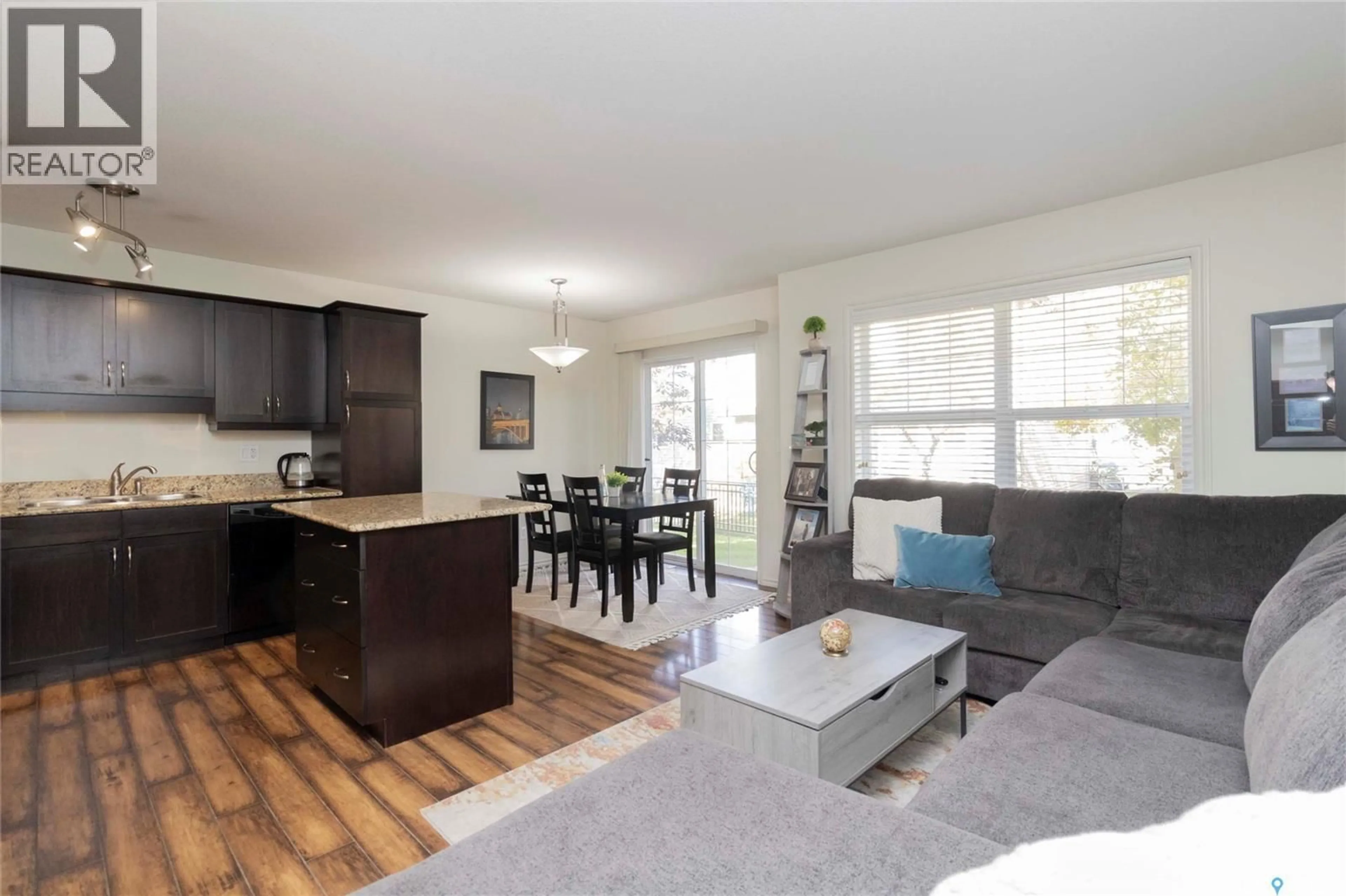 Living room with furniture, wood/laminate floor for 615 - 105 LYND CRESCENT, Saskatoon Saskatchewan S7T0G7