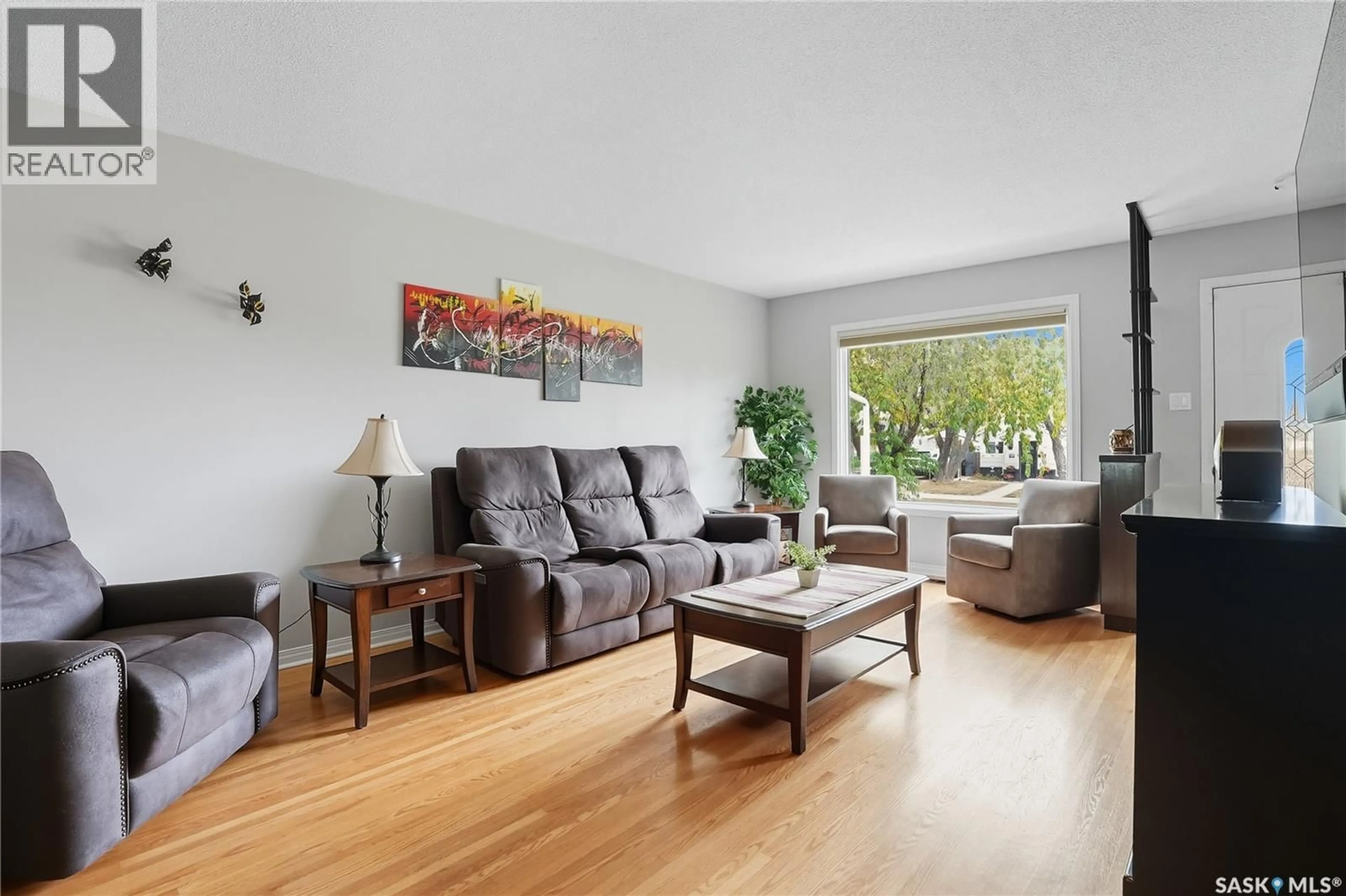 Living room with furniture, wood/laminate floor for 1042 J AVENUE, Saskatoon Saskatchewan S7L2L4