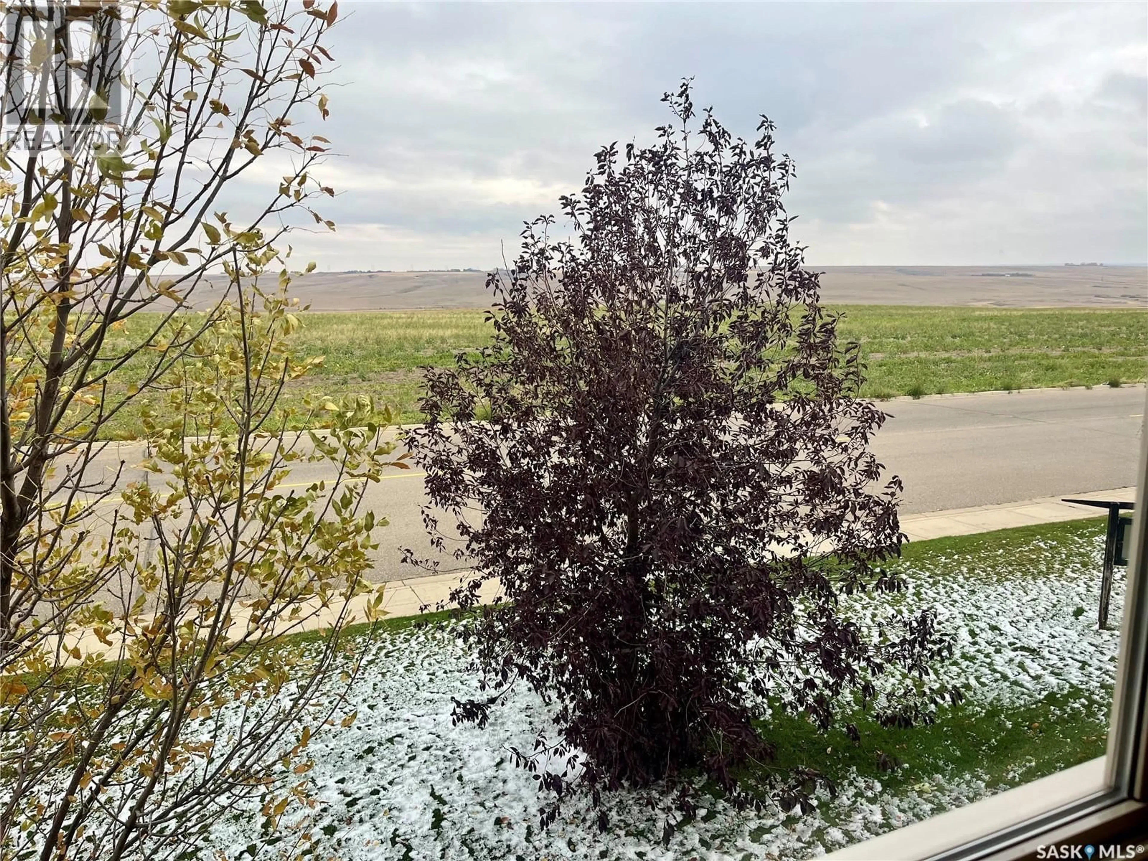 A pic from outside/outdoor area/front of a property/back of a property/a pic from drone, forest/trees view for 700 - 521 BATTLEFORD TRAIL, Swift Current Saskatchewan S9H4V9