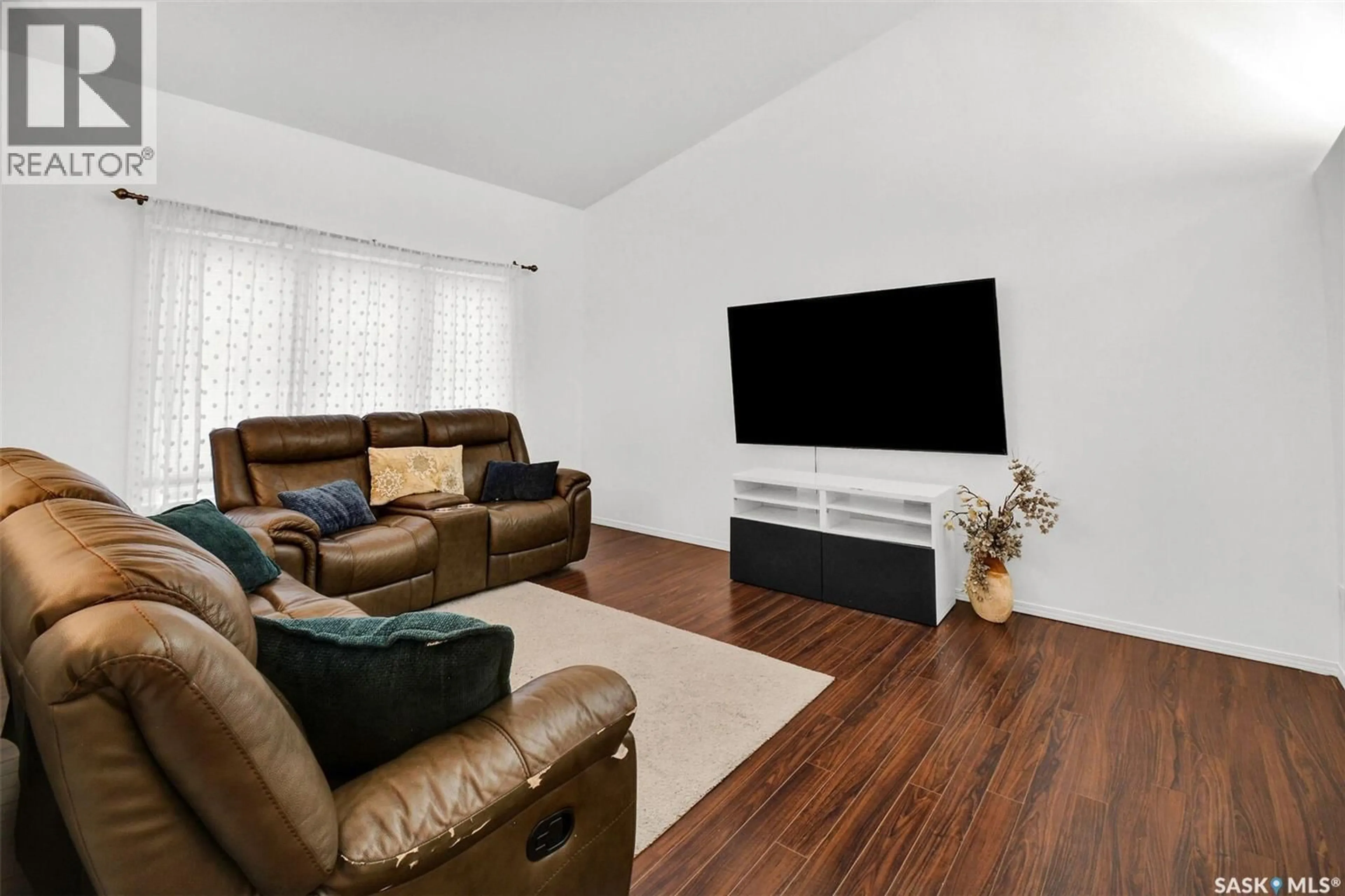 Living room with furniture, wood/laminate floor for 1526 PATON CRESCENT, Saskatoon Saskatchewan S7W0C3