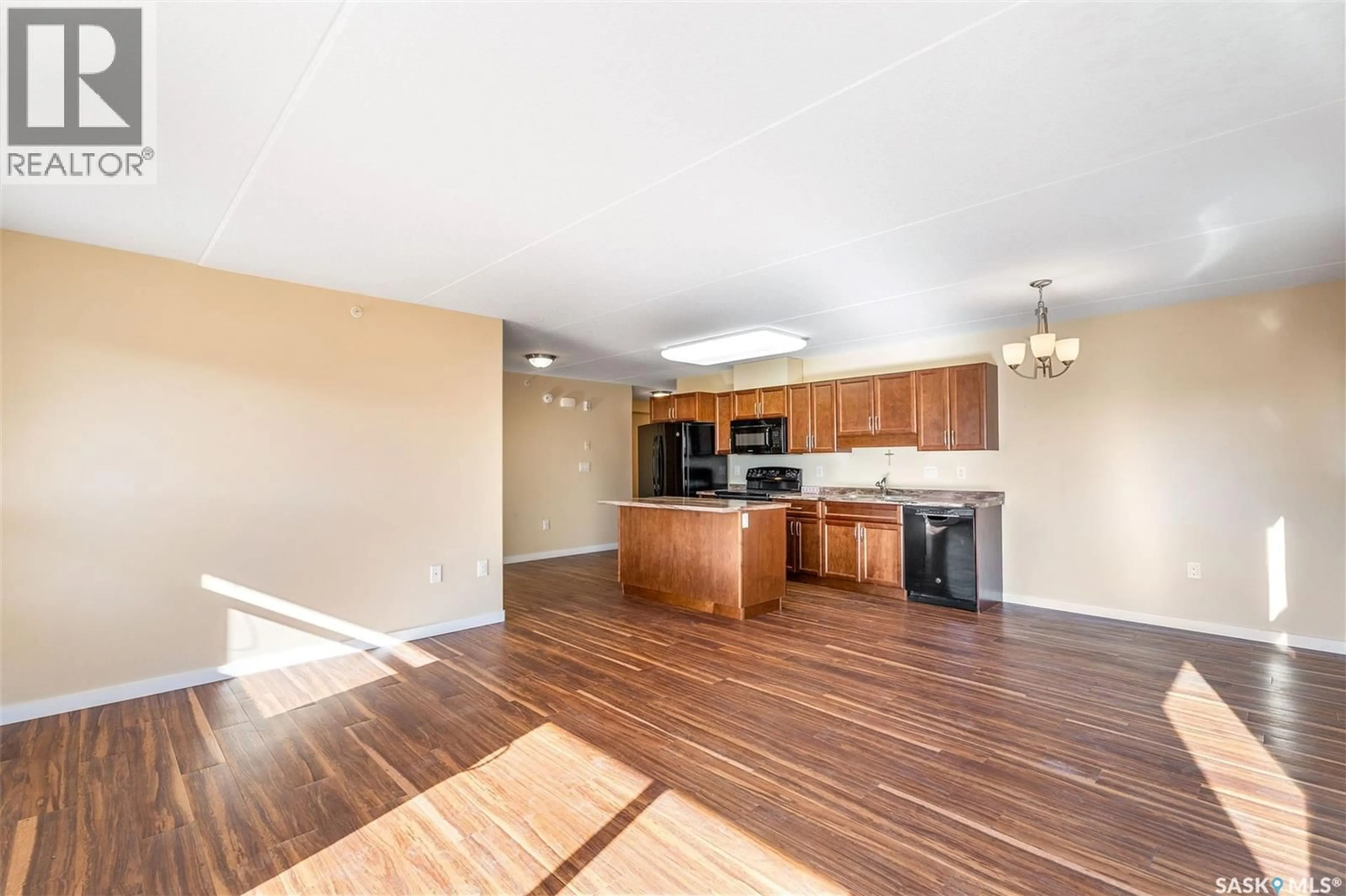 Open concept kitchen, wood/laminate floor for 208 - 2761 WOODBRIDGE DRIVE, Prince Albert Saskatchewan S6V3Z9
