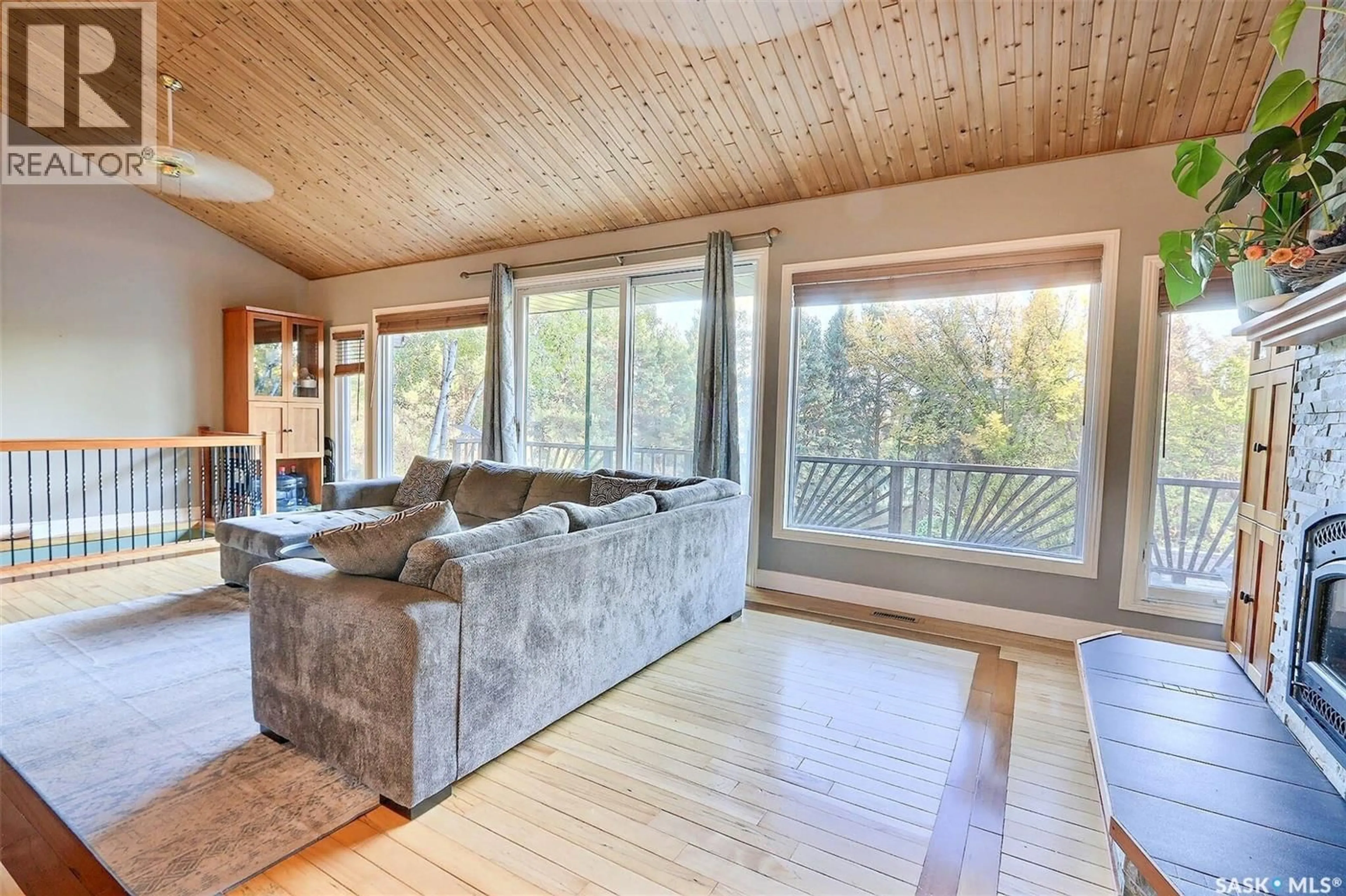 Living room with furniture, wood/laminate floor for 358 PINE DRIVE, Buckland Rm No. 491 Saskatchewan S6V5R3