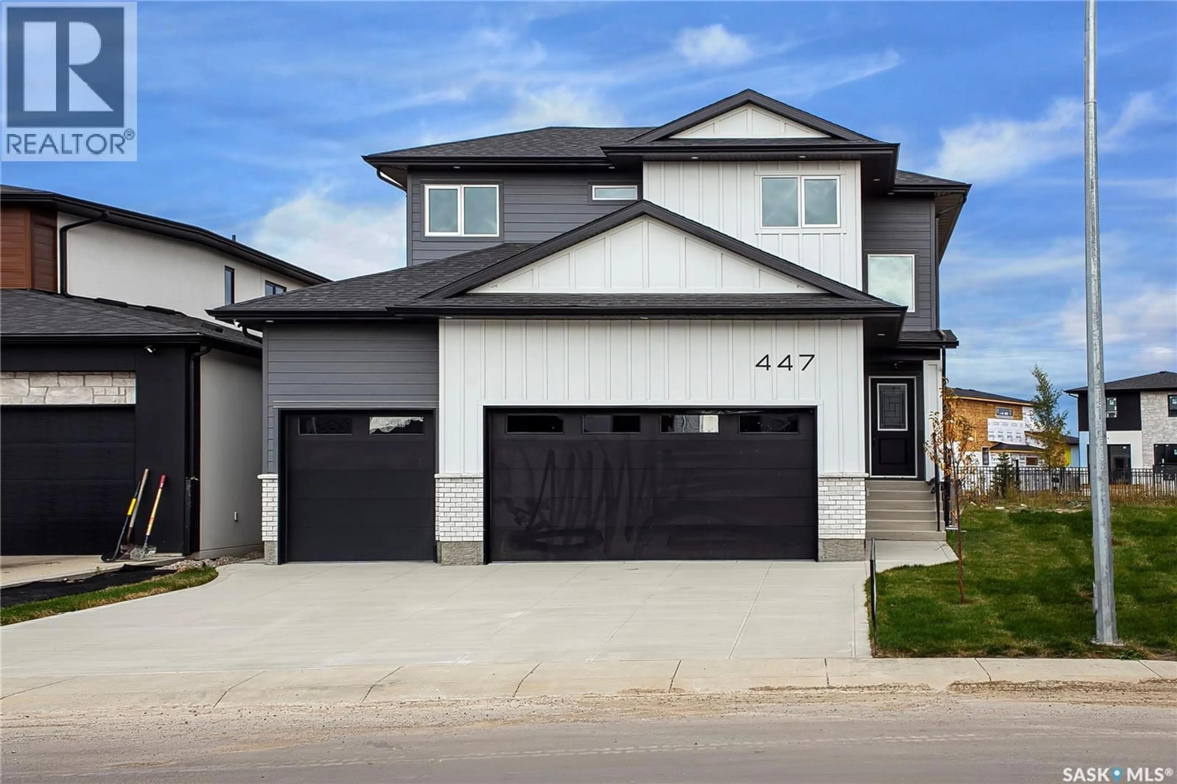 Home with vinyl exterior material, street for 447 WOOLF BEND, Saskatoon Saskatchewan S7W1E4