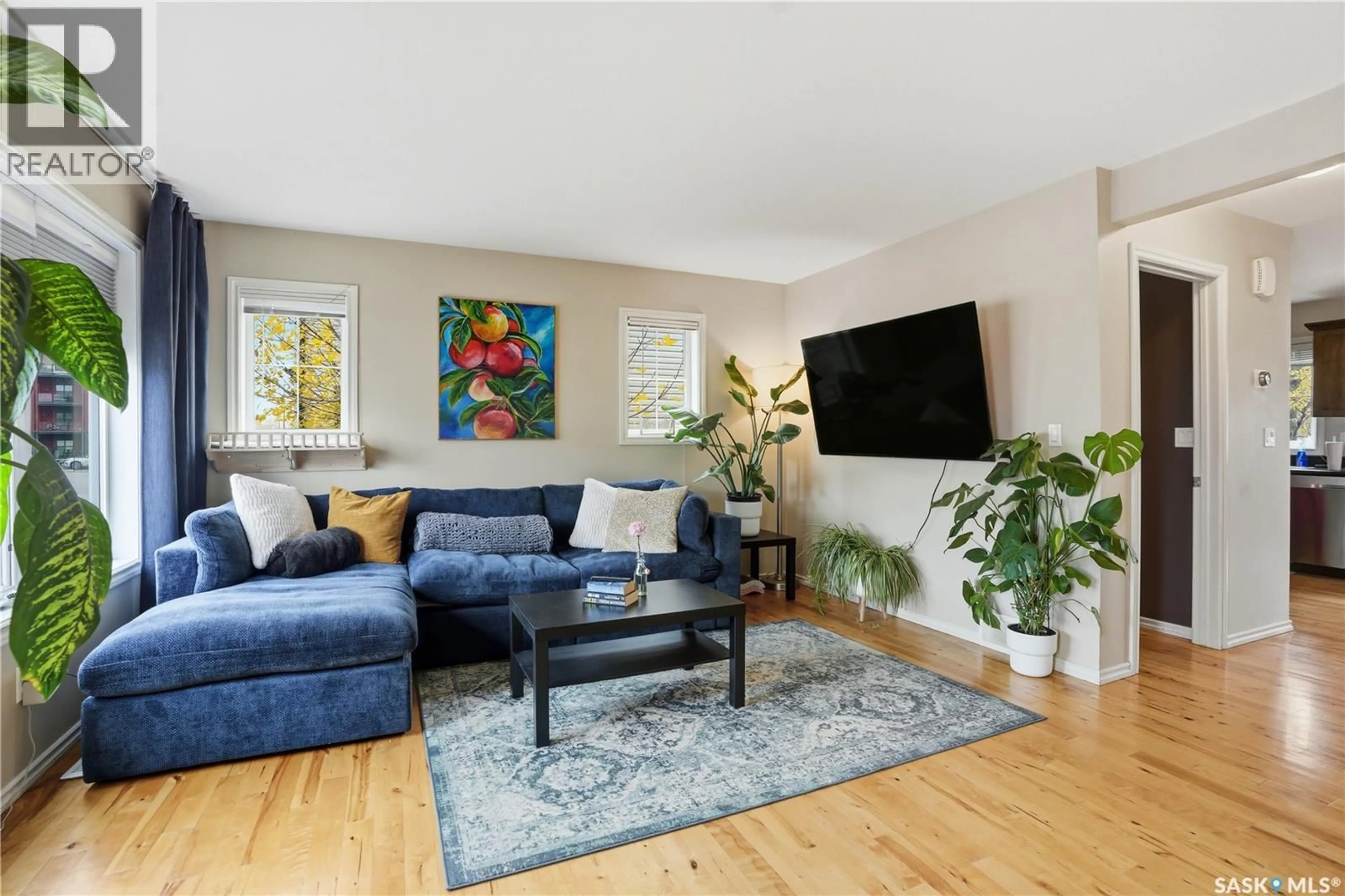 Living room with furniture, wood/laminate floor for 303 - 626 SLIMMON PLACE, Saskatoon Saskatchewan S7V0A8