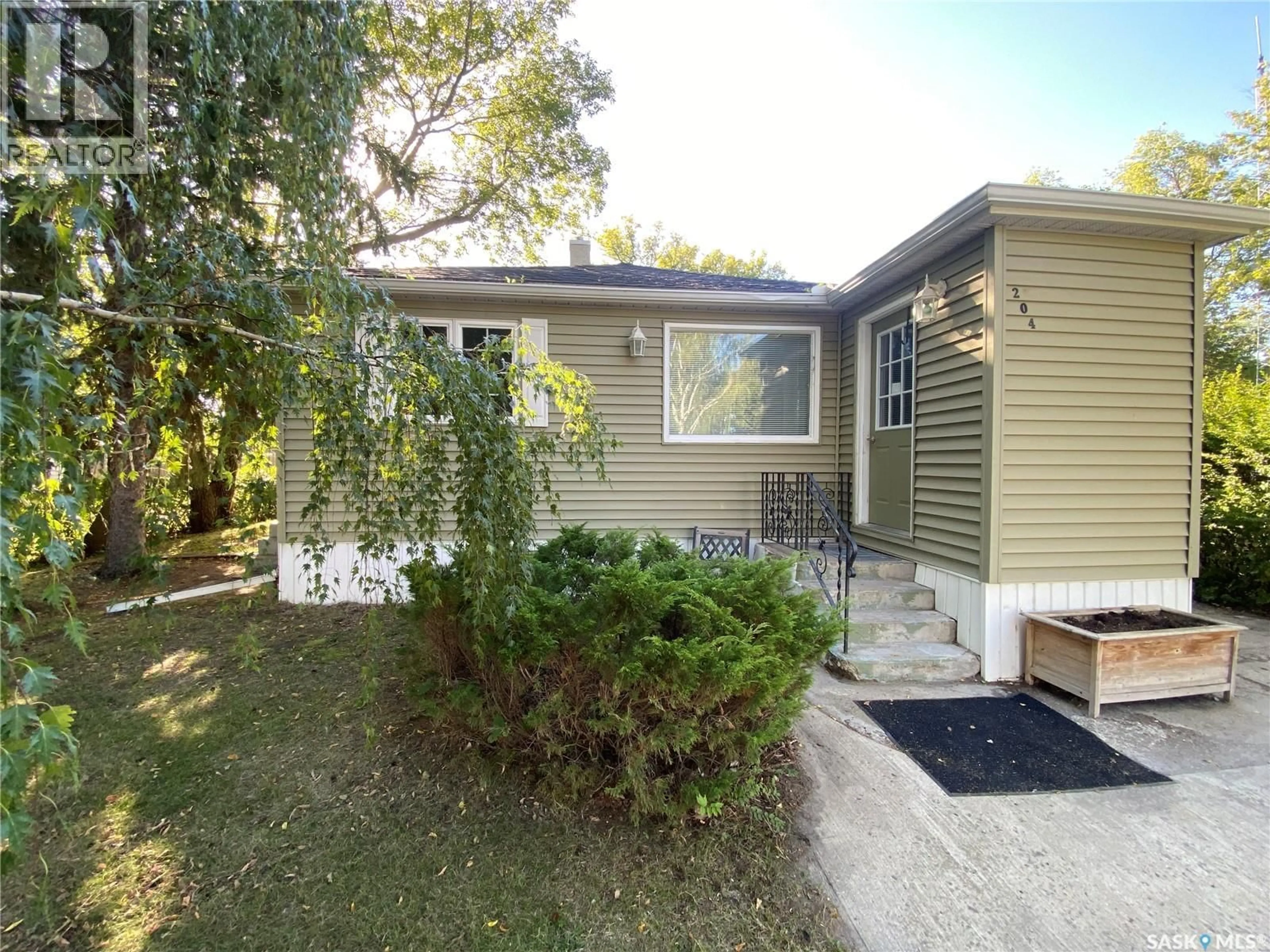 Home with vinyl exterior material, street for E - 204 4TH STREET, Carnduff Saskatchewan S0C0S0