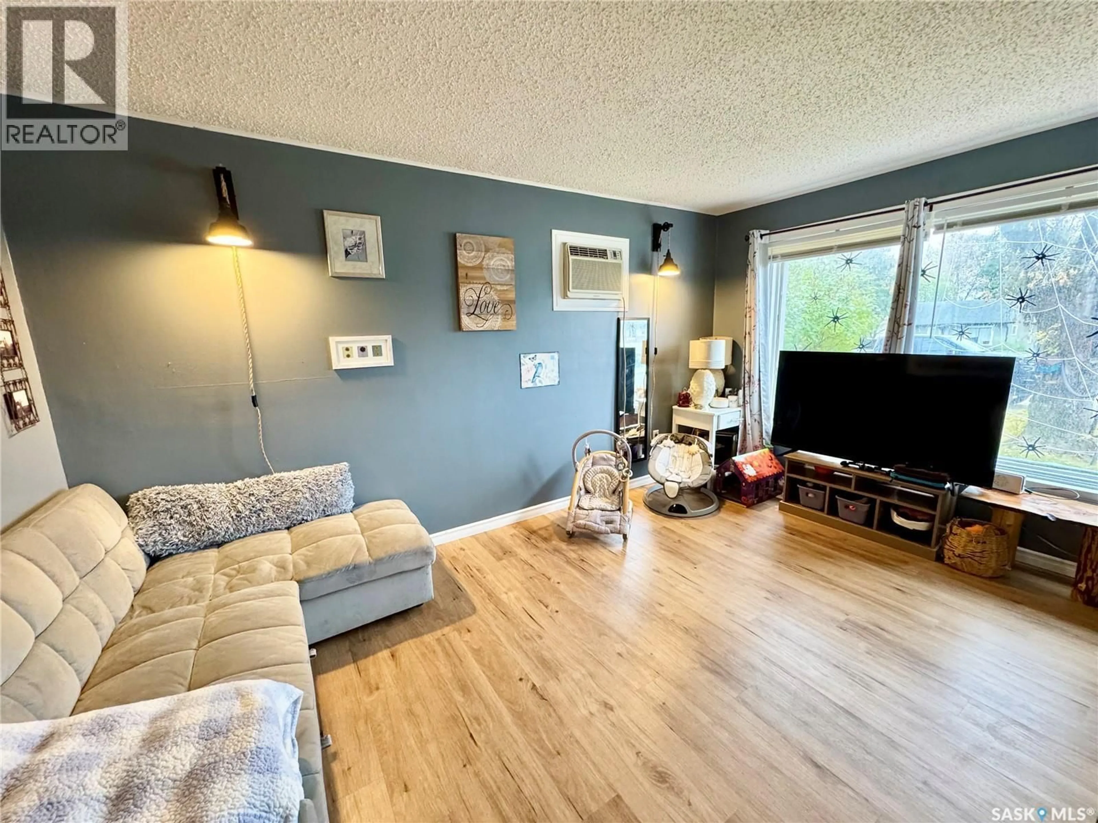 Living room with furniture, wood/laminate floor for 748 5TH STREET, Prince Albert Saskatchewan S6V0M5