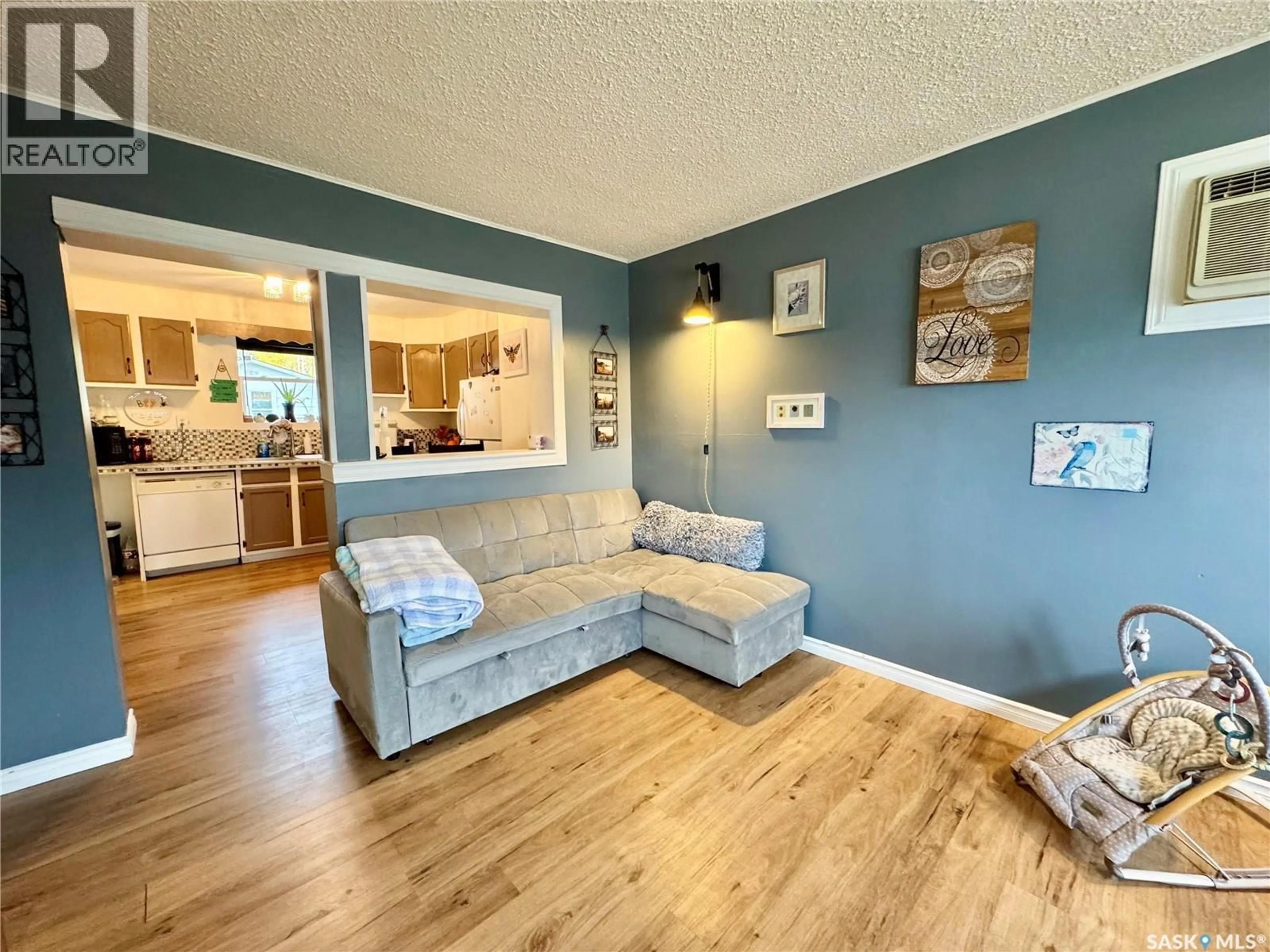 Living room with furniture, wood/laminate floor for 748 5TH STREET, Prince Albert Saskatchewan S6V0M5