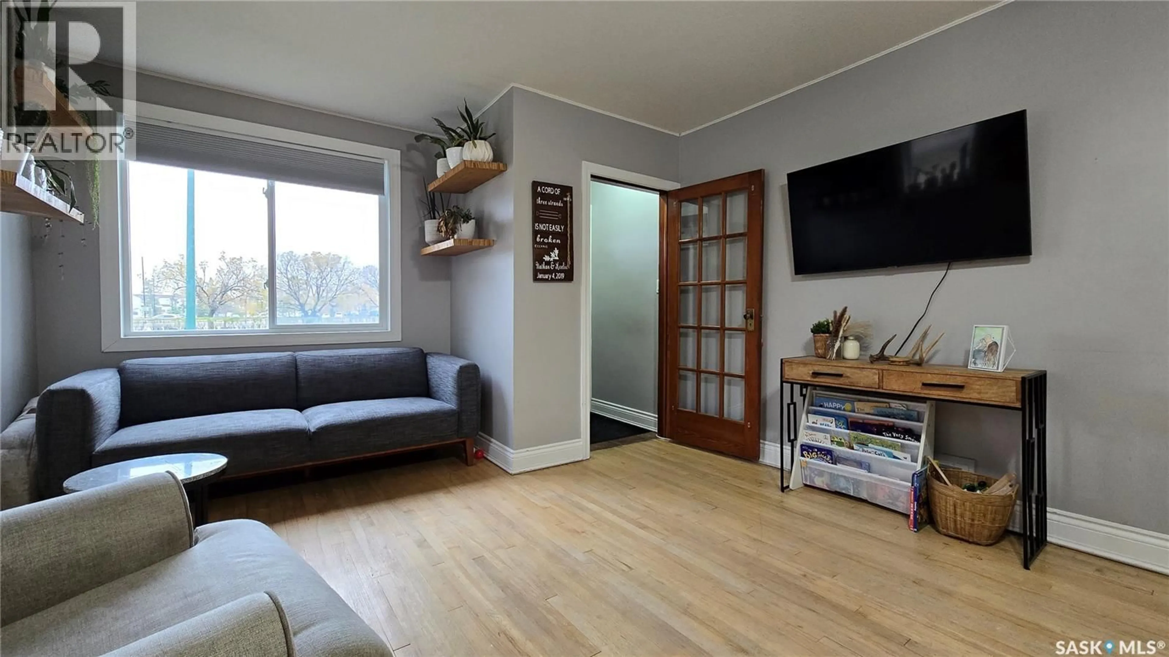 Living room with furniture, wood/laminate floor for 5038 DEWDNEY AVENUE, Regina Saskatchewan S4T1B9