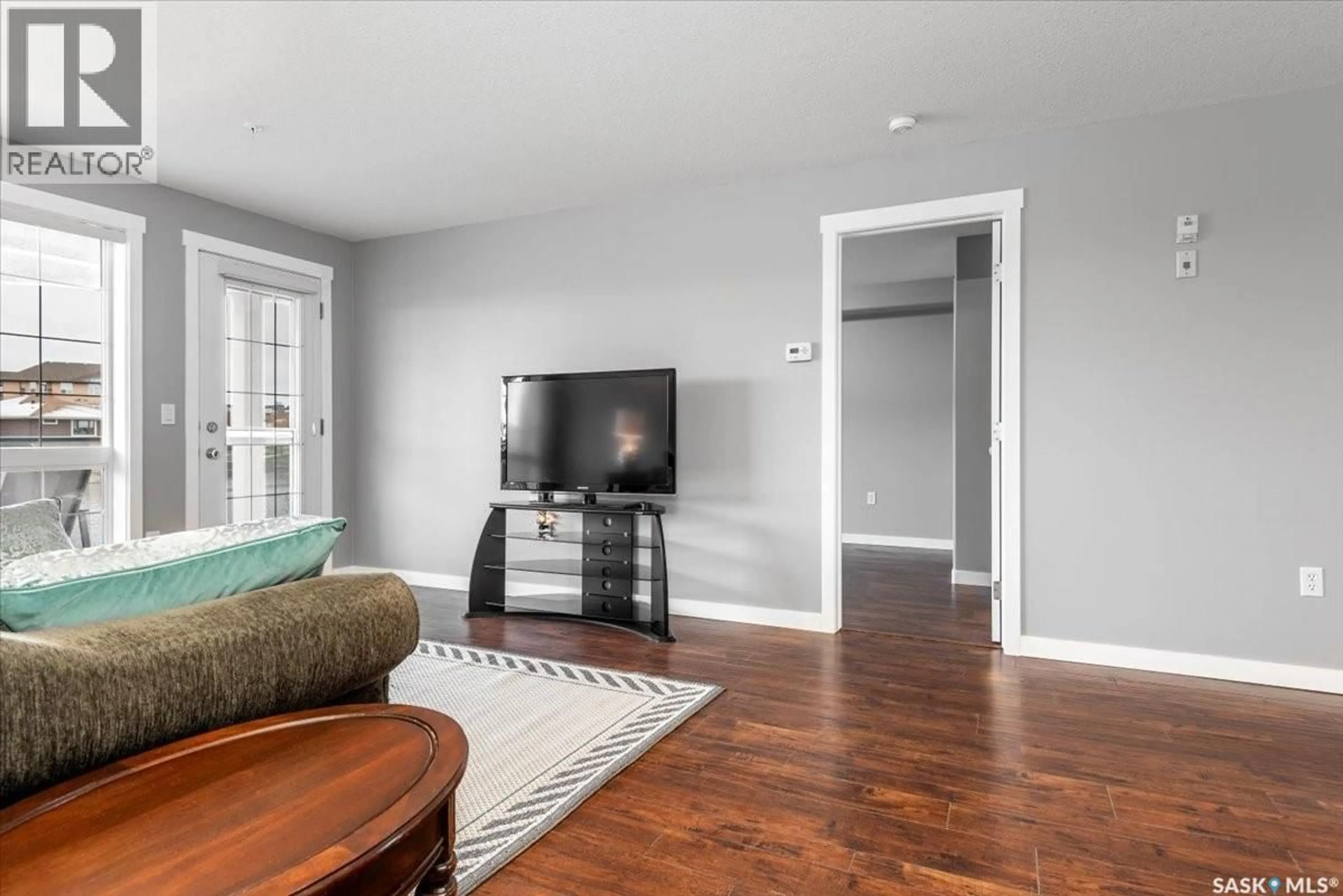 Living room with furniture, wood/laminate floor for 108 2300 TELL PLACE, Regina Saskatchewan S4V3C3