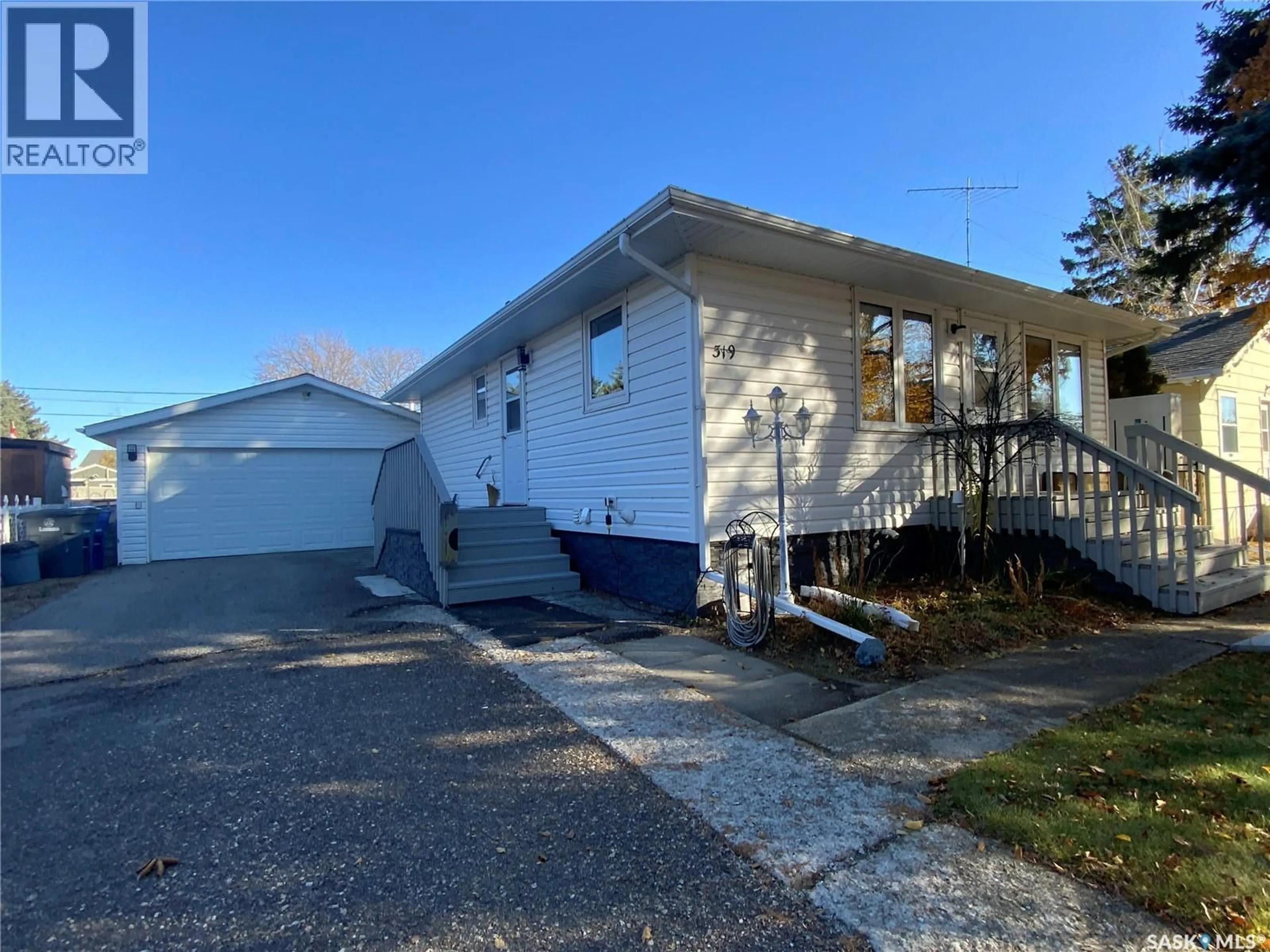Home with vinyl exterior material, street for 319 SIMPSON STREET, Outlook Saskatchewan S0L2N0