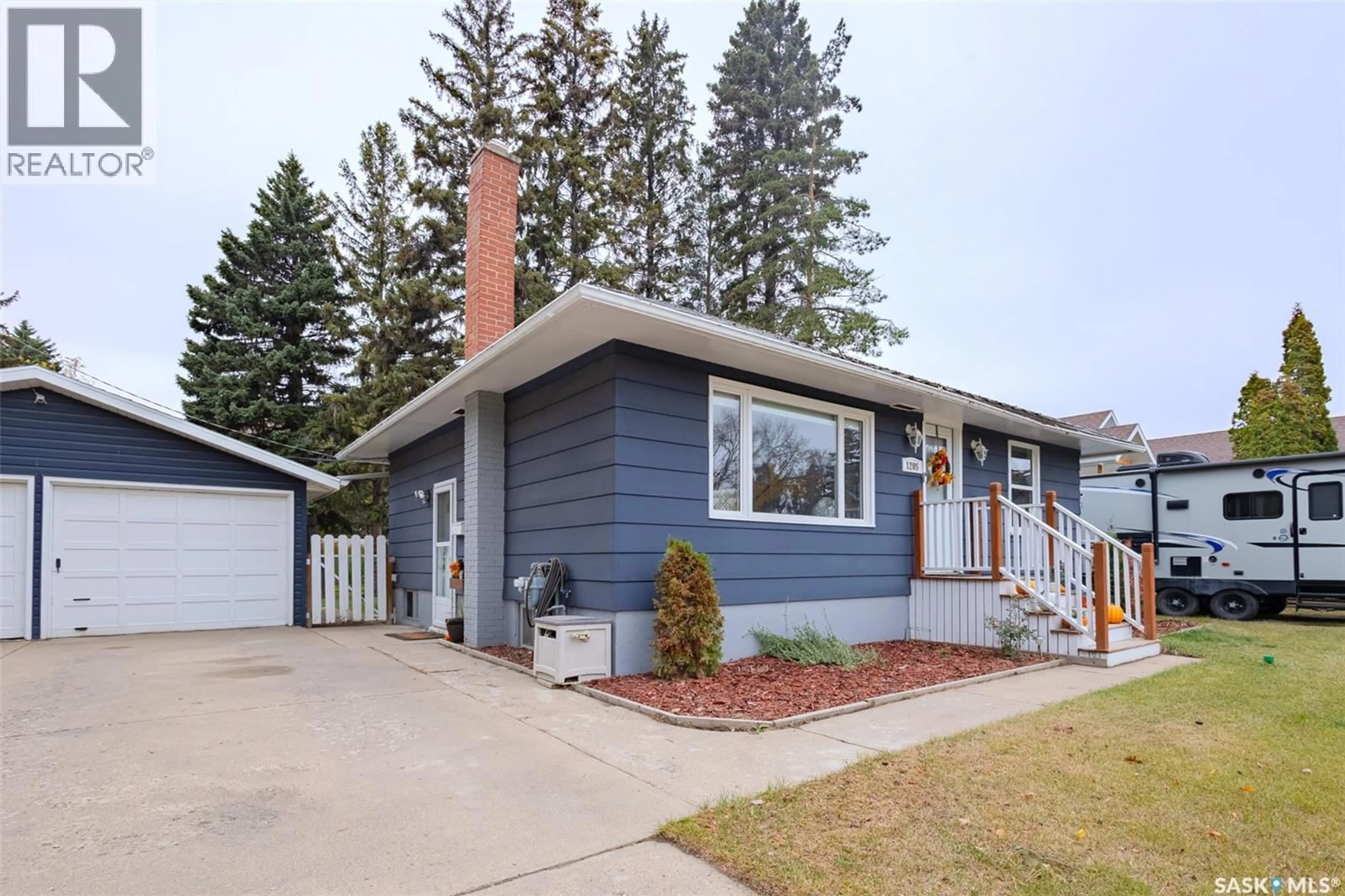 Home with vinyl exterior material, street for 1205 LANCASTER BOULEVARD, Saskatoon Saskatchewan S7M3V6