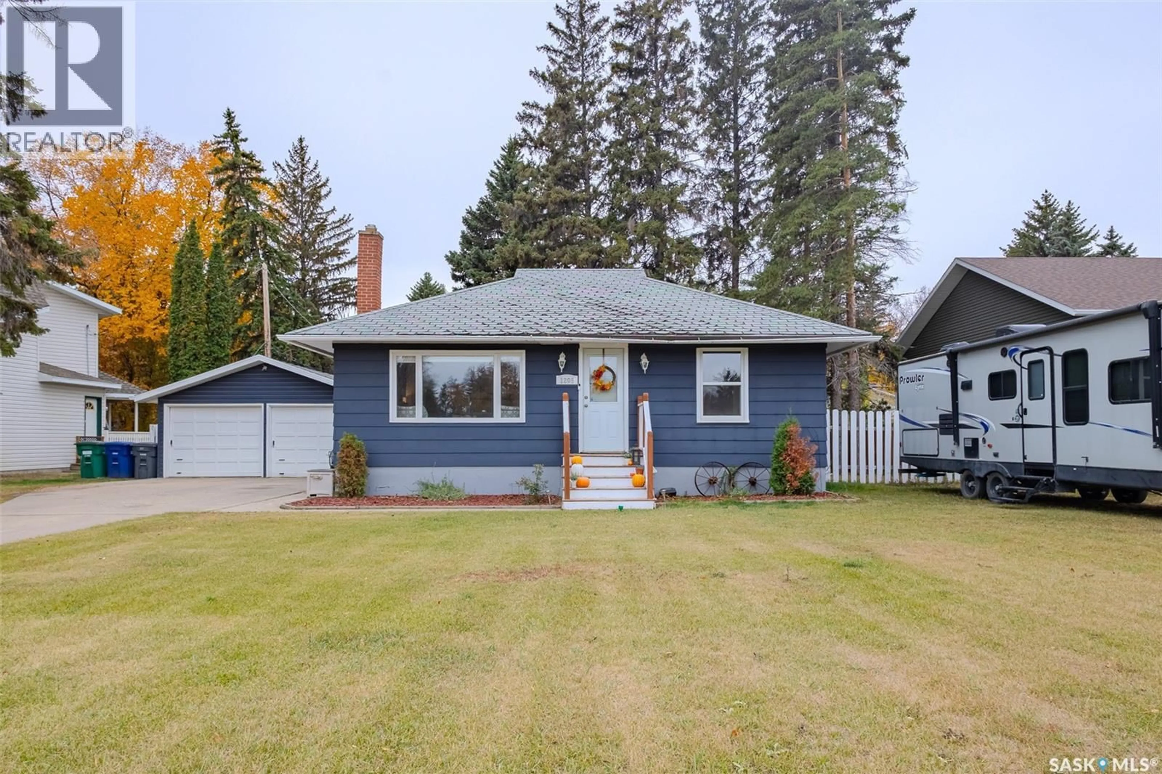 Home with vinyl exterior material, street for 1205 LANCASTER BOULEVARD, Saskatoon Saskatchewan S7M3V6