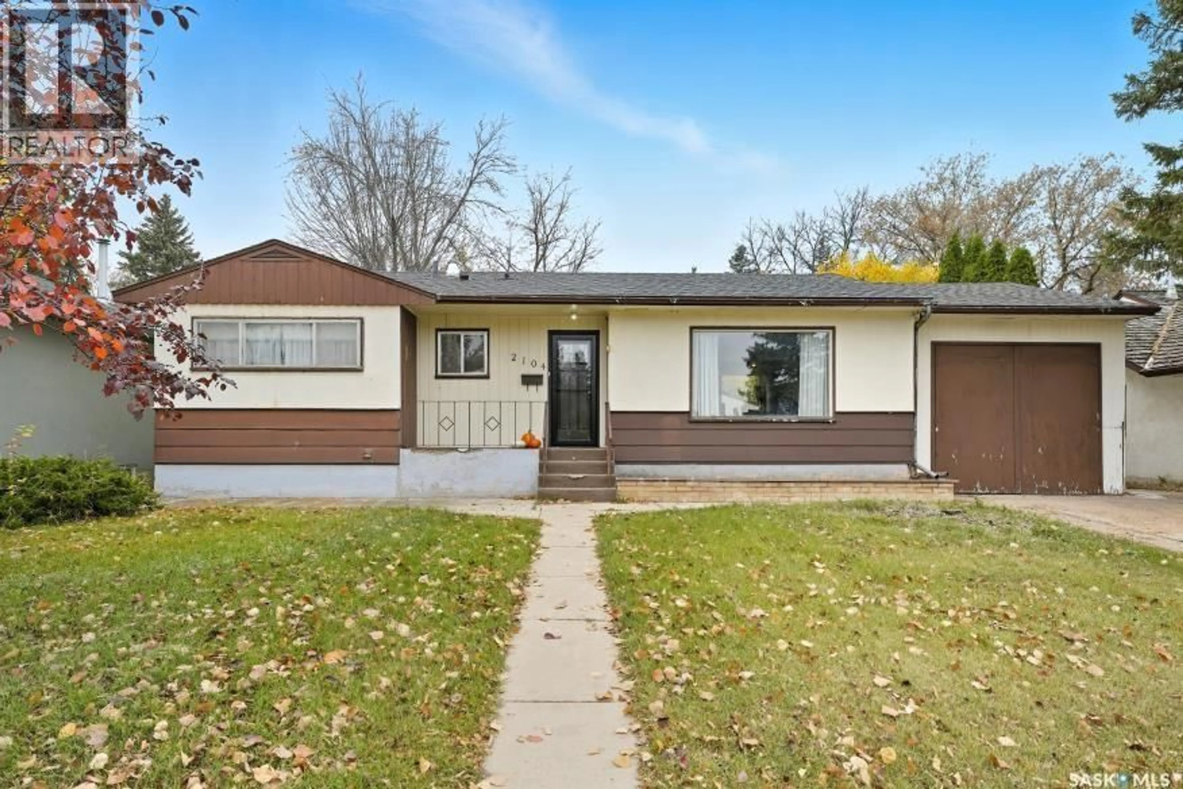Home with vinyl exterior material, street for 2104 CLARENCE AVENUE, Saskatoon Saskatchewan S7J1L5