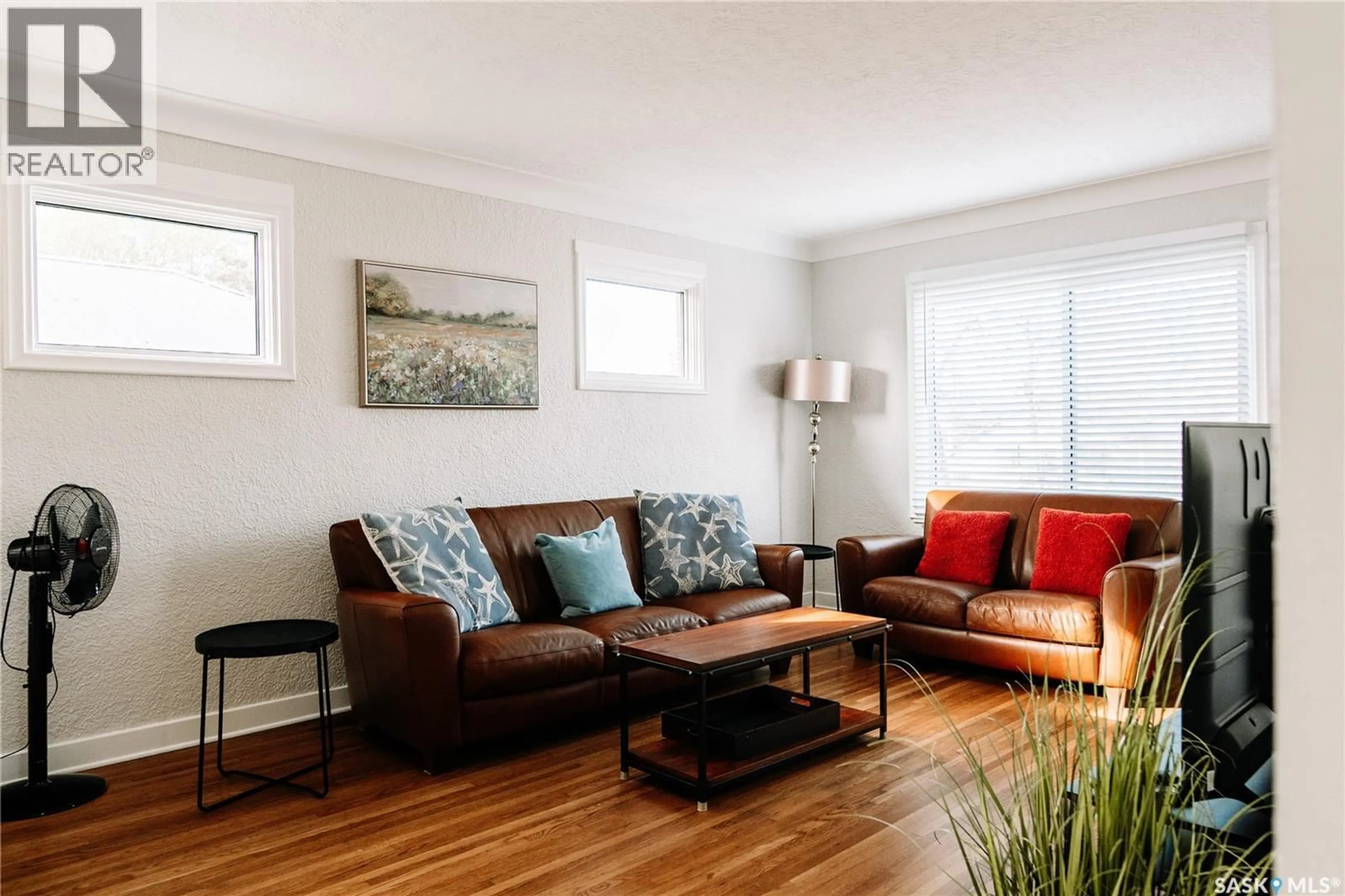 Living room with furniture, wood/laminate floor for 111 COLLEGE AVENUE, Regina Saskatchewan S4N0W4