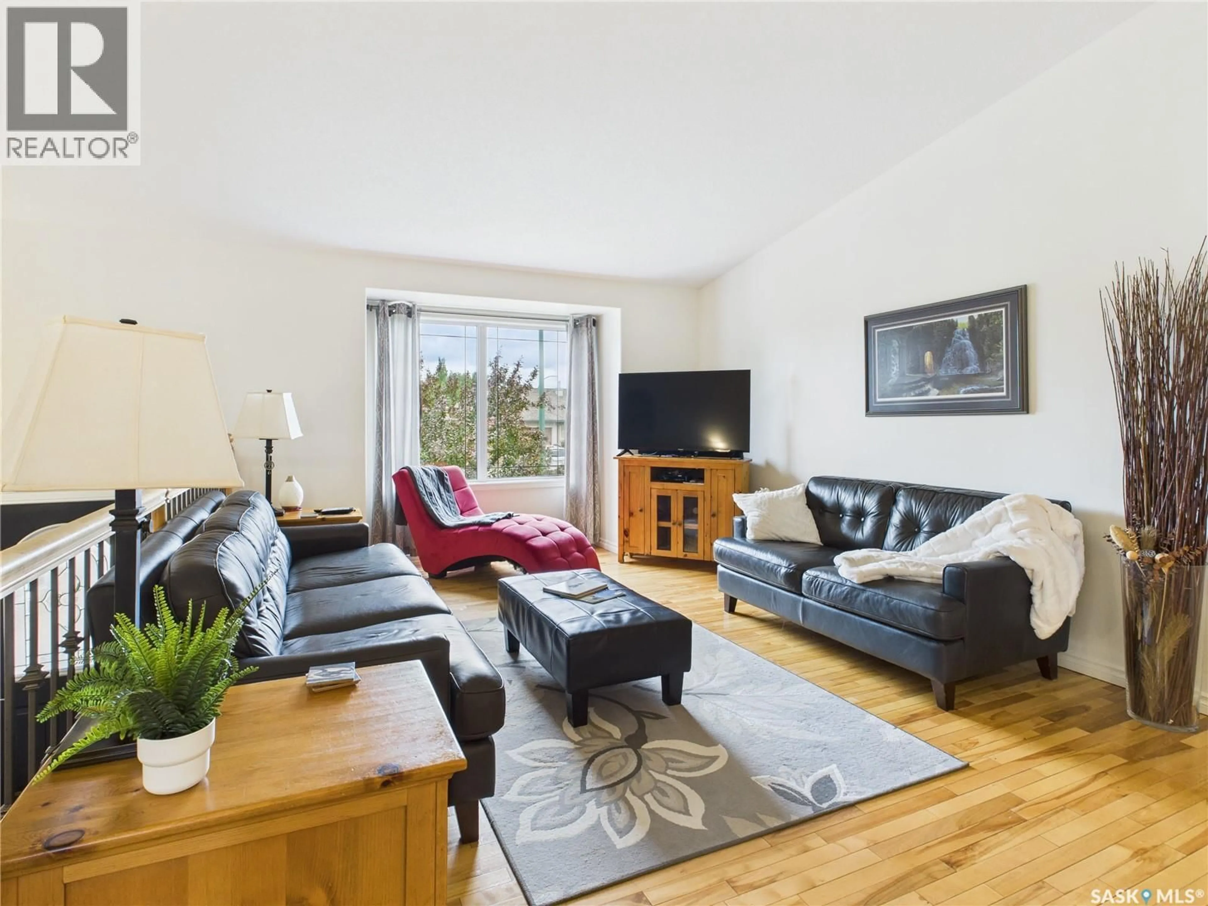 Living room with furniture, wood/laminate floor for 615 CASEY ROAD, Prince Albert Saskatchewan S6V8C9