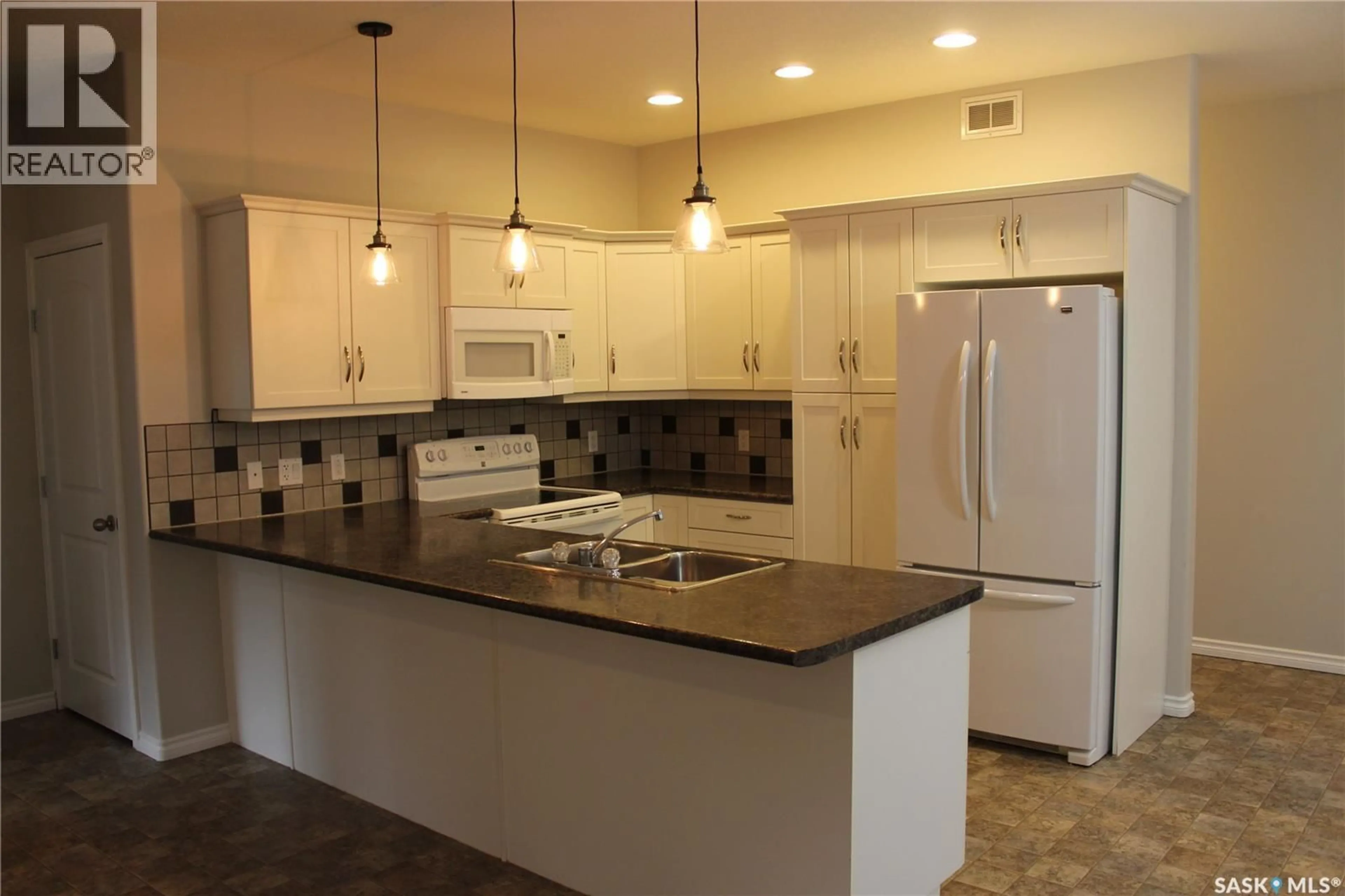 Open concept kitchen, ceramic/tile floor for 106 ERICKSON STREET, Midale Saskatchewan S0C1S0