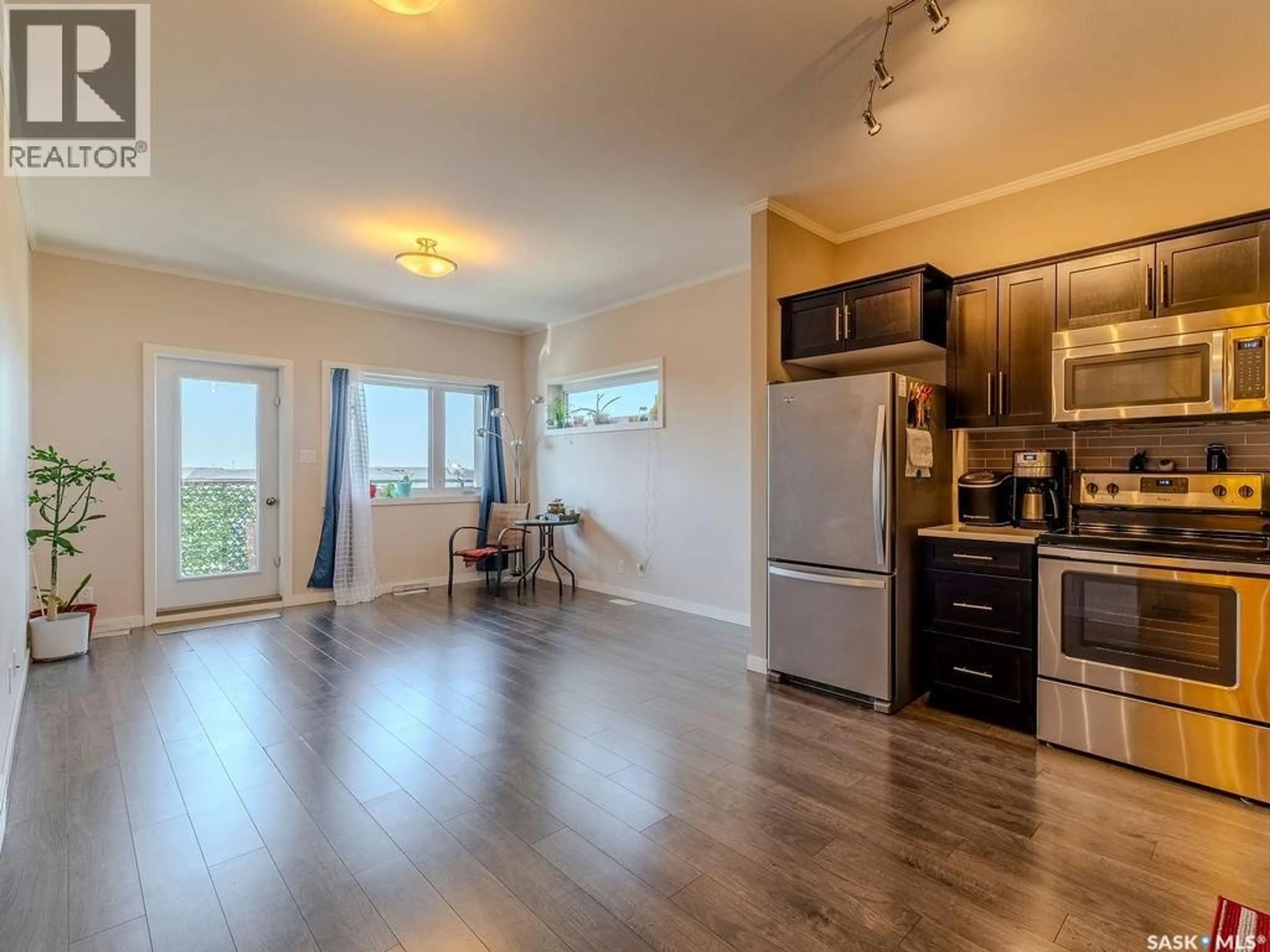 Open concept kitchen, wood/laminate floor for 302 720 BALTZAN BOULEVARD, Saskatoon Saskatchewan S7W0W6